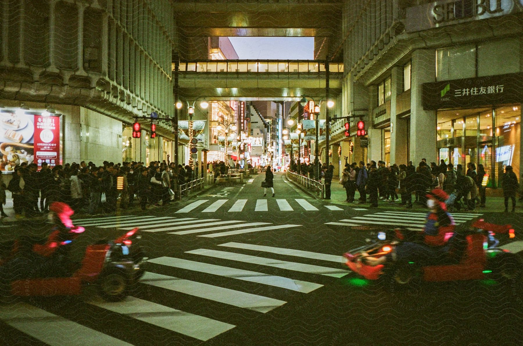 A lot of people outdoors in a city at night