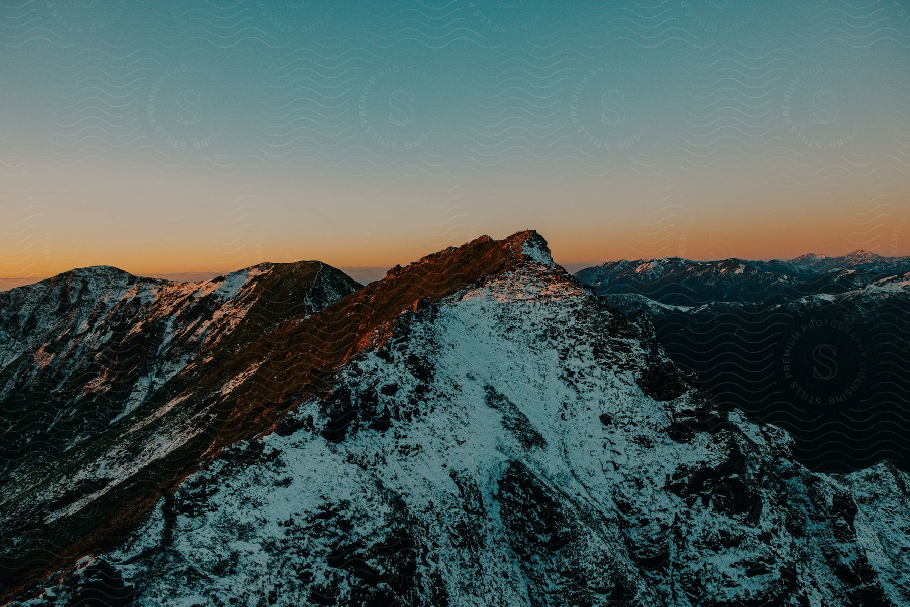 Landscape in a morning with red sky and mountains and peaks with snow
