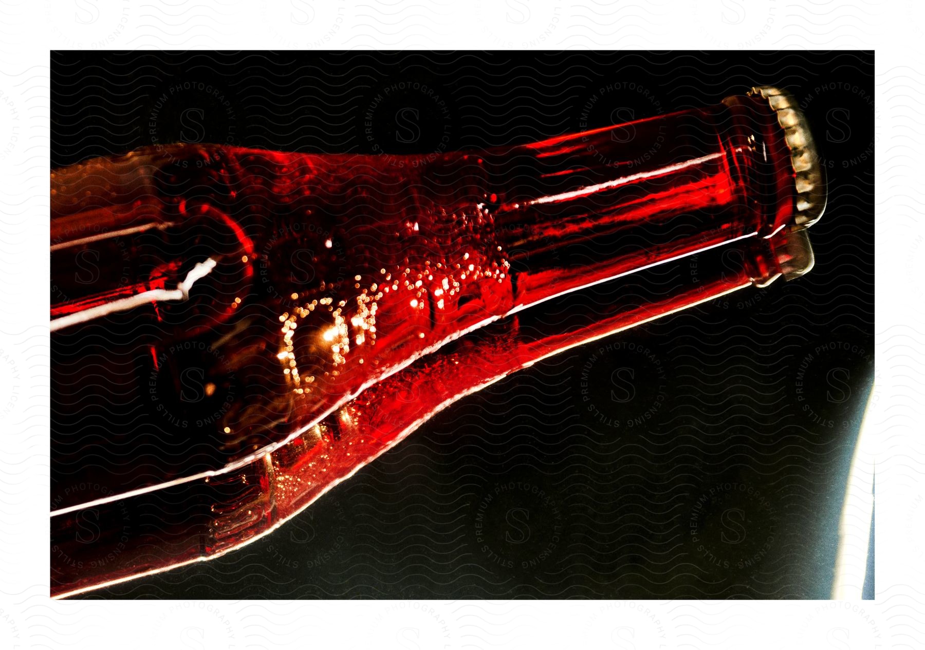 A mirrored image of a glass bottle of soda pop.
