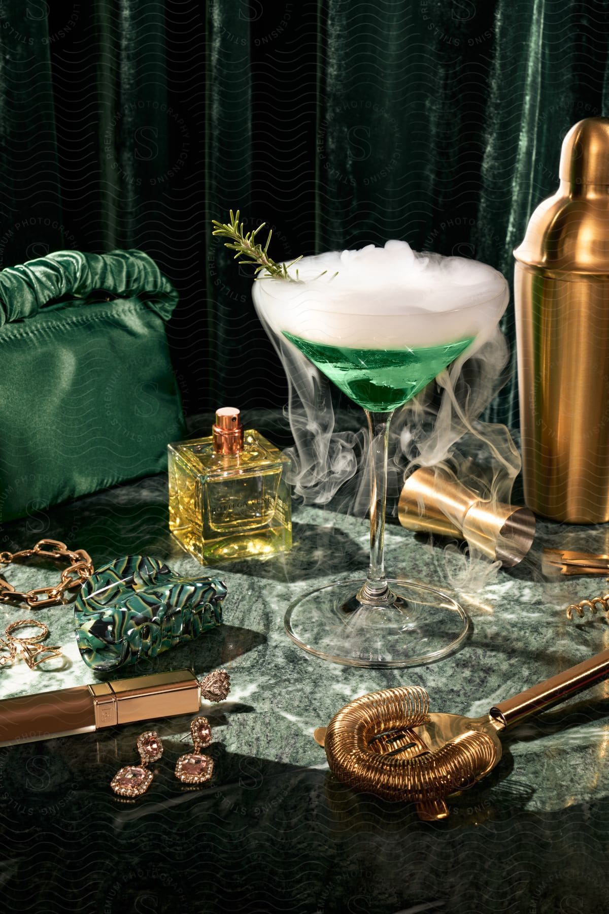 Greenish cocktail in a crystal glass with jeweled handbags around