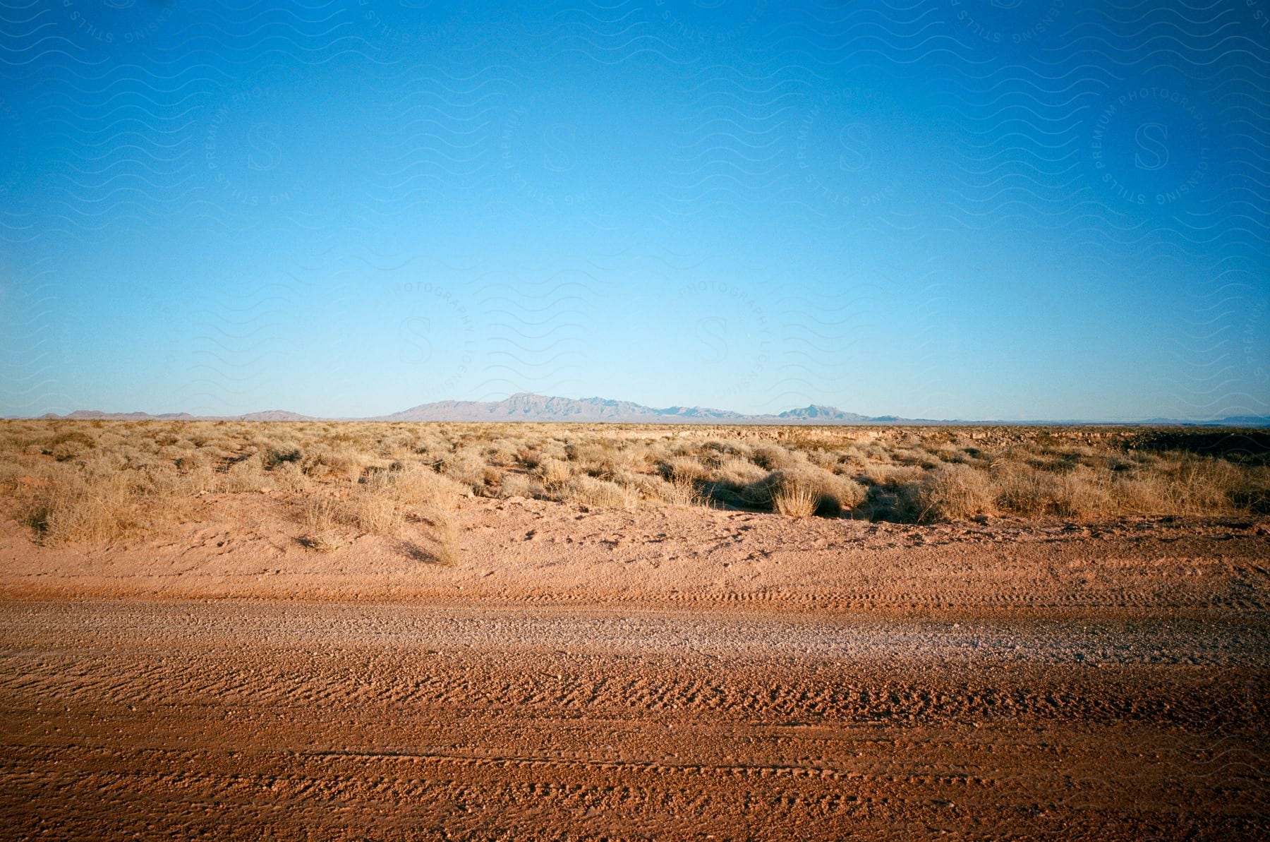 rural road is in the middle of the desert landscape