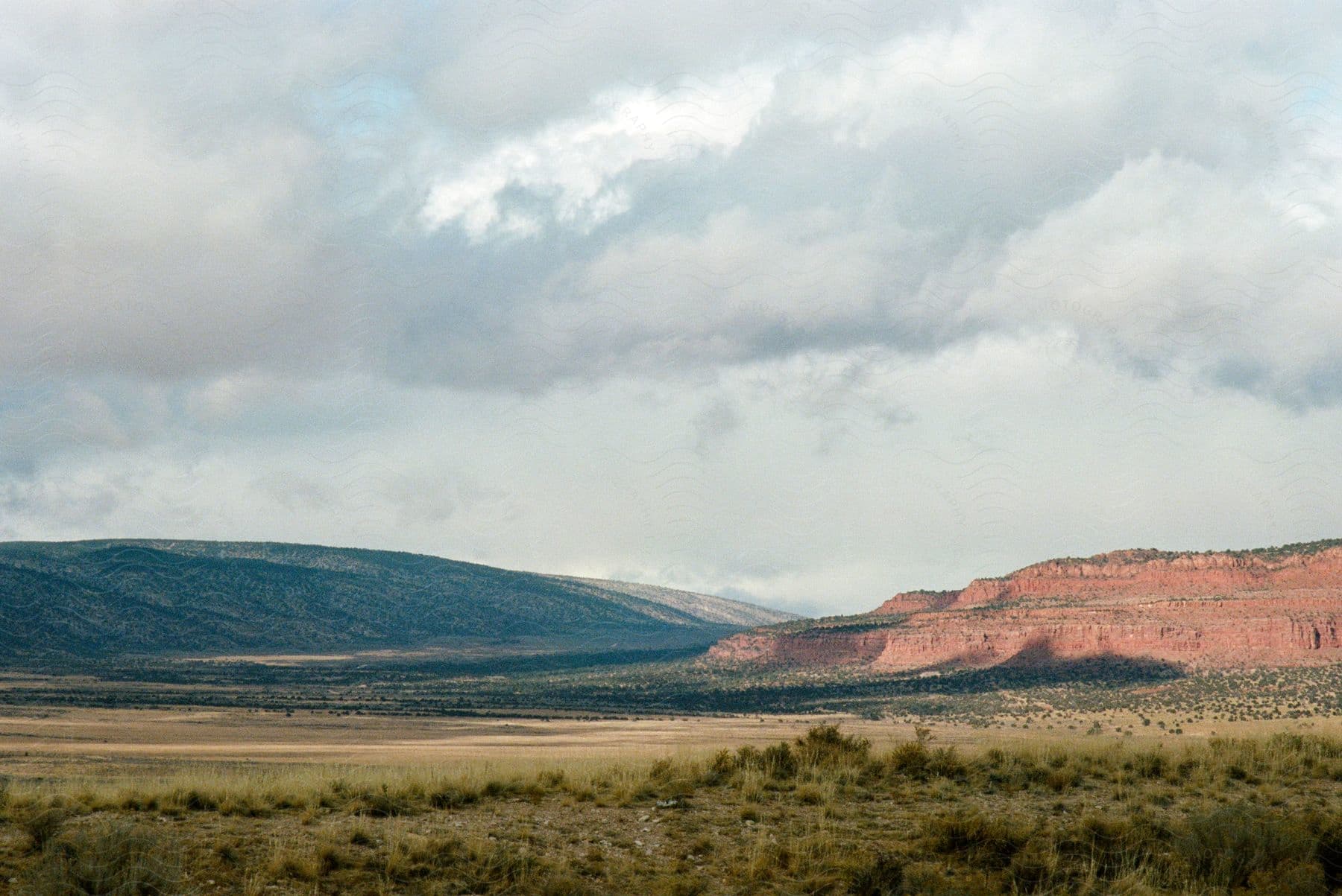 Natural landscape of mountains with vegetation next to canyons on a clear day with clouds