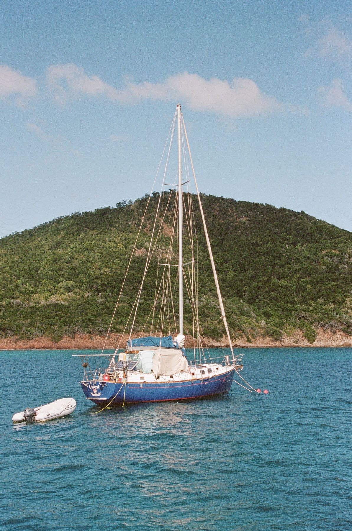 A sailboat sailing off the coast.