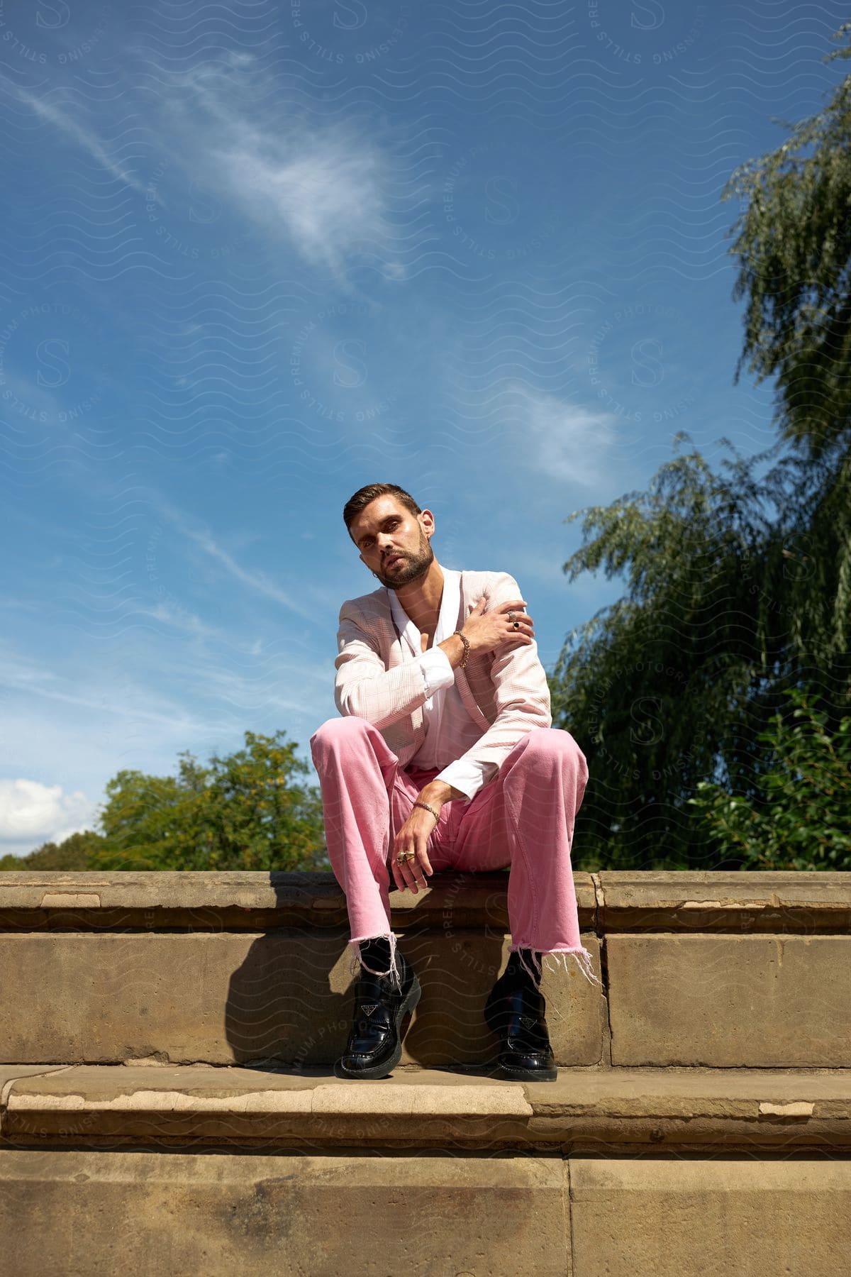 A man sitting on a staircase with clear sky's in the background