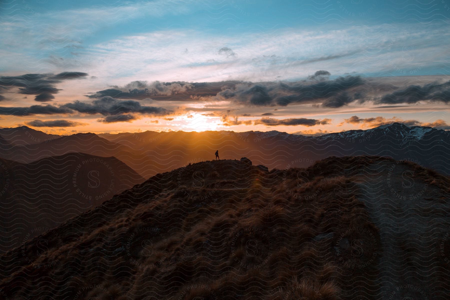 A person hiking at the top of a mountain area