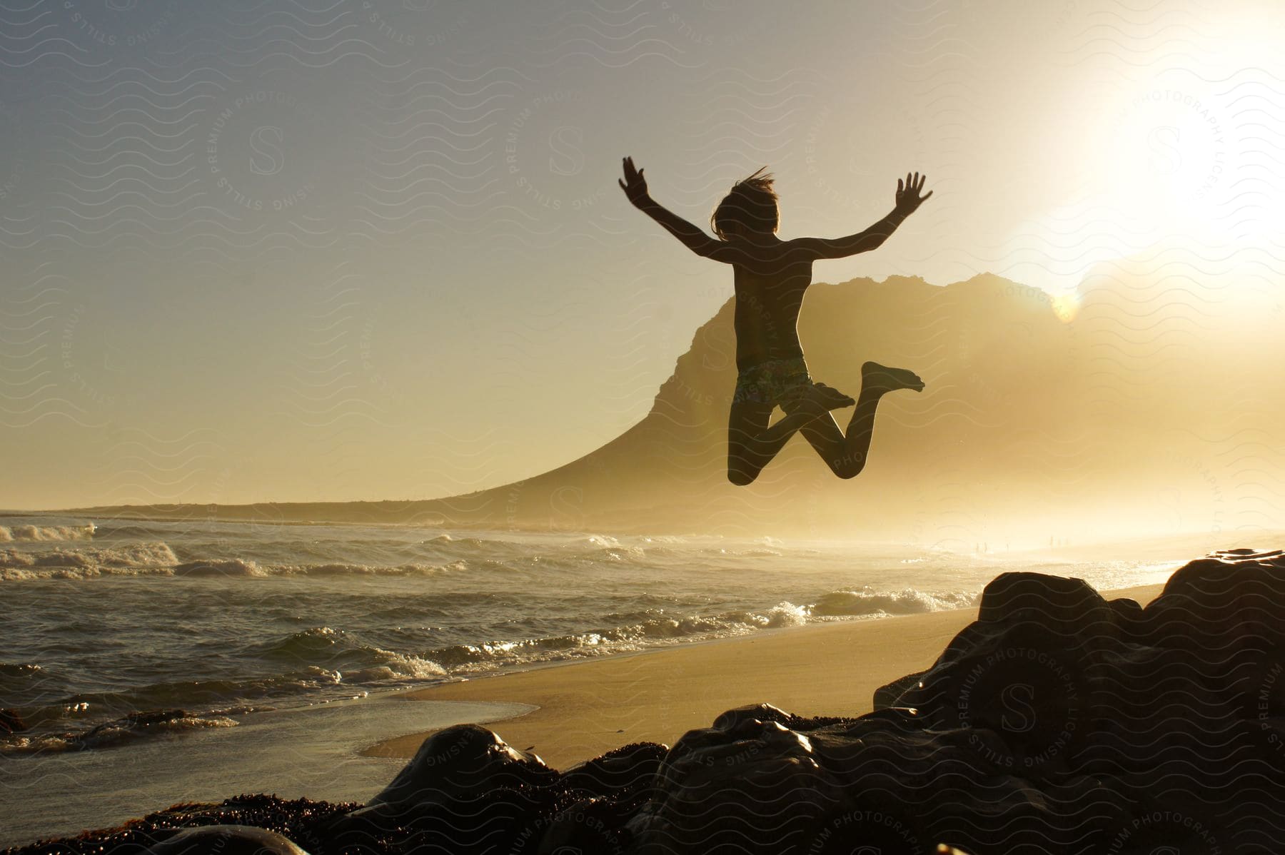 A person jumping with joy out on the beach