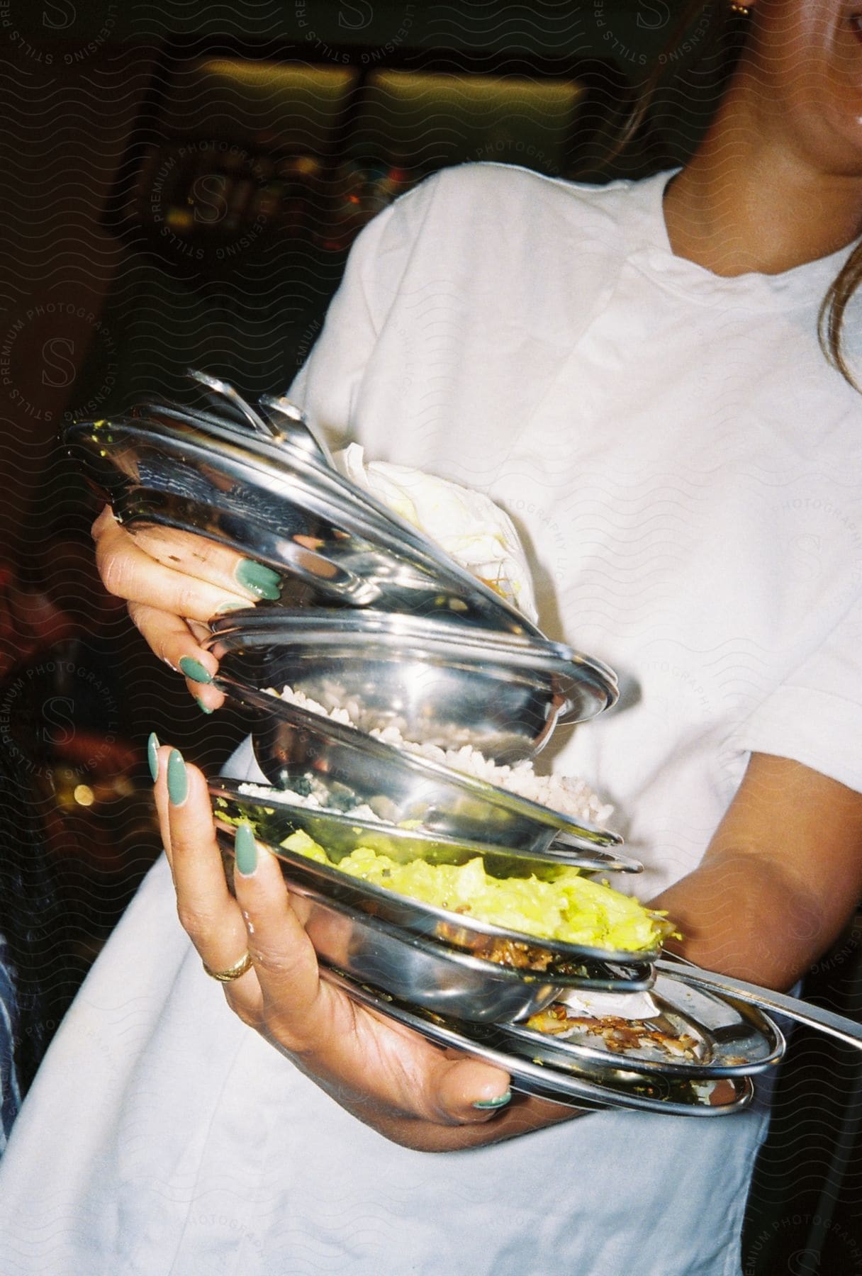 Waitress carrying a stack of plates of food