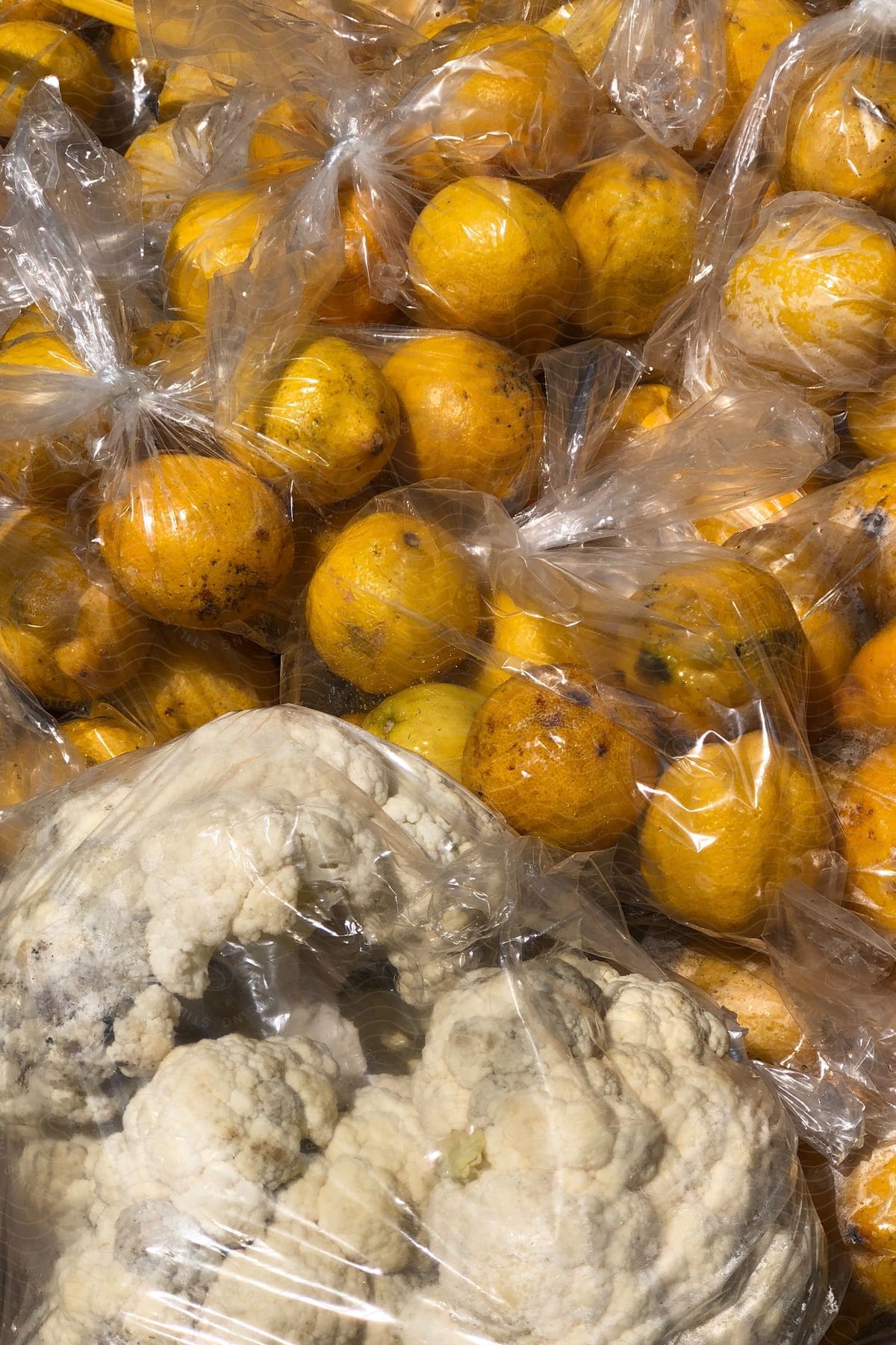 Bags of oranges and cauliflower