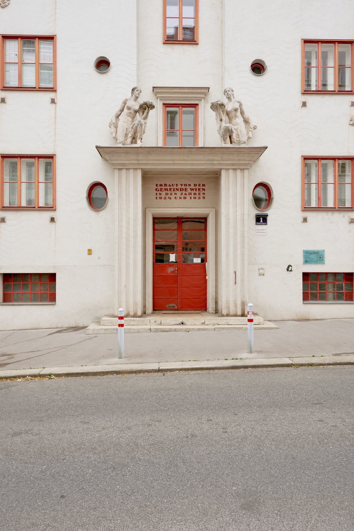 A multi-storied schoolhouse in Vienna with a red front door.