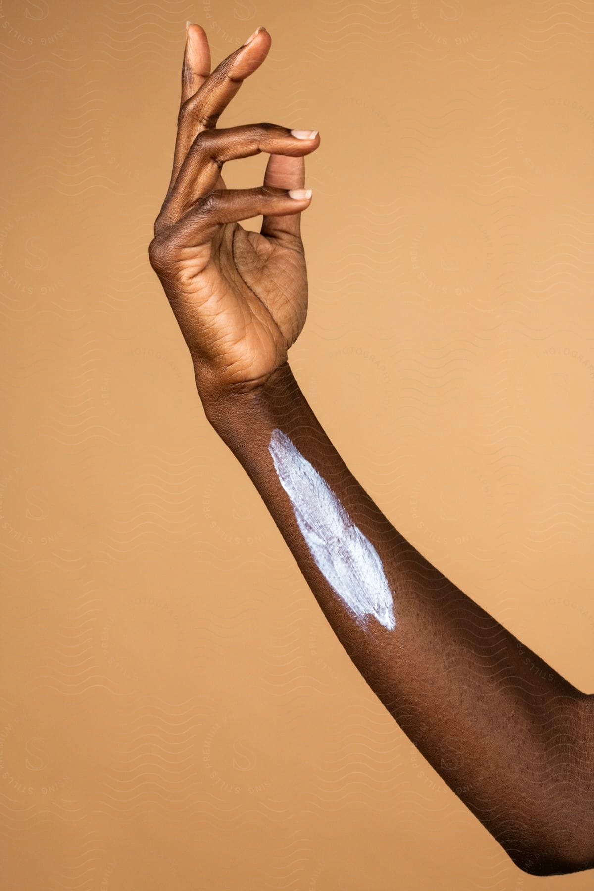 A woman's arm with lotion on it.