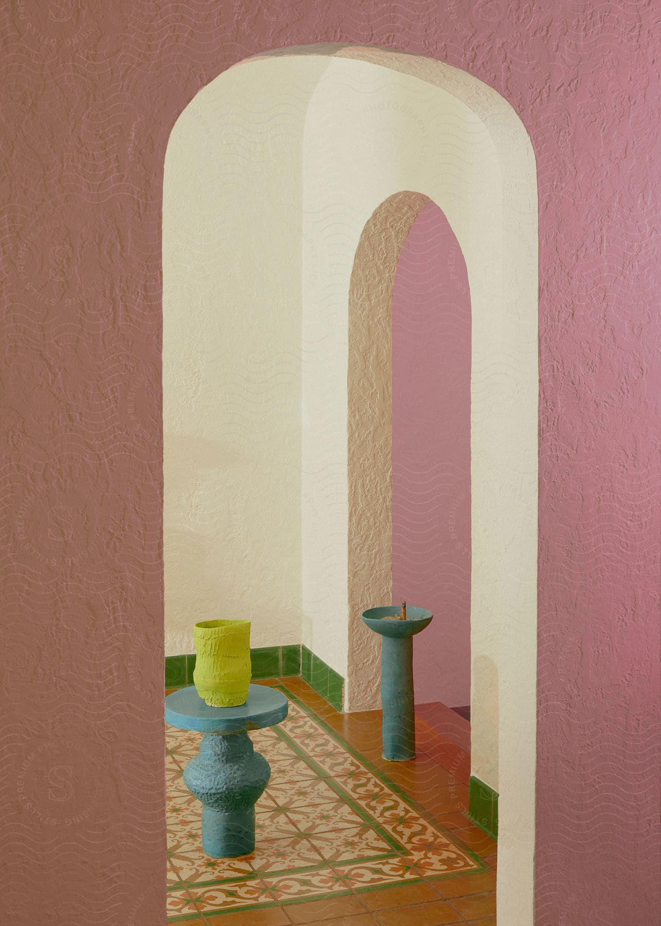 Arched doorway with textured walls in pastel colors, featuring a patterned tile floor and two modern candle holders.Arched doorway with textured walls in pastel colors, featuring a patterned tile floor and two modern candle holders.