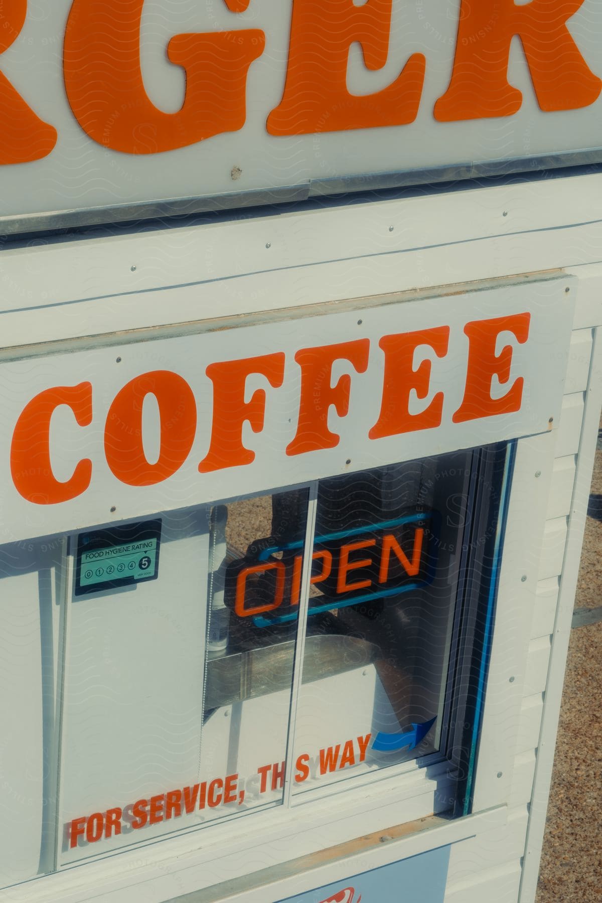 A coffee shop sign on the side of a building reads "Tiger Coffee".