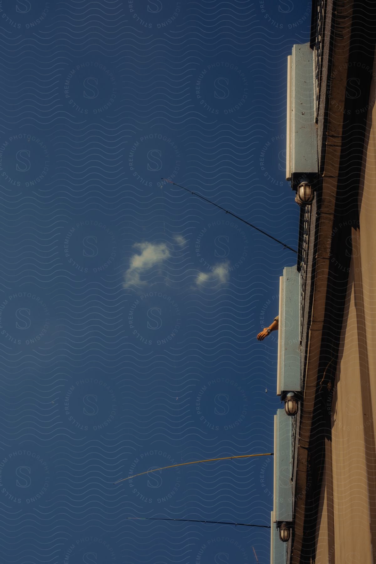 Boxes with antennas extending from them on a side of a building