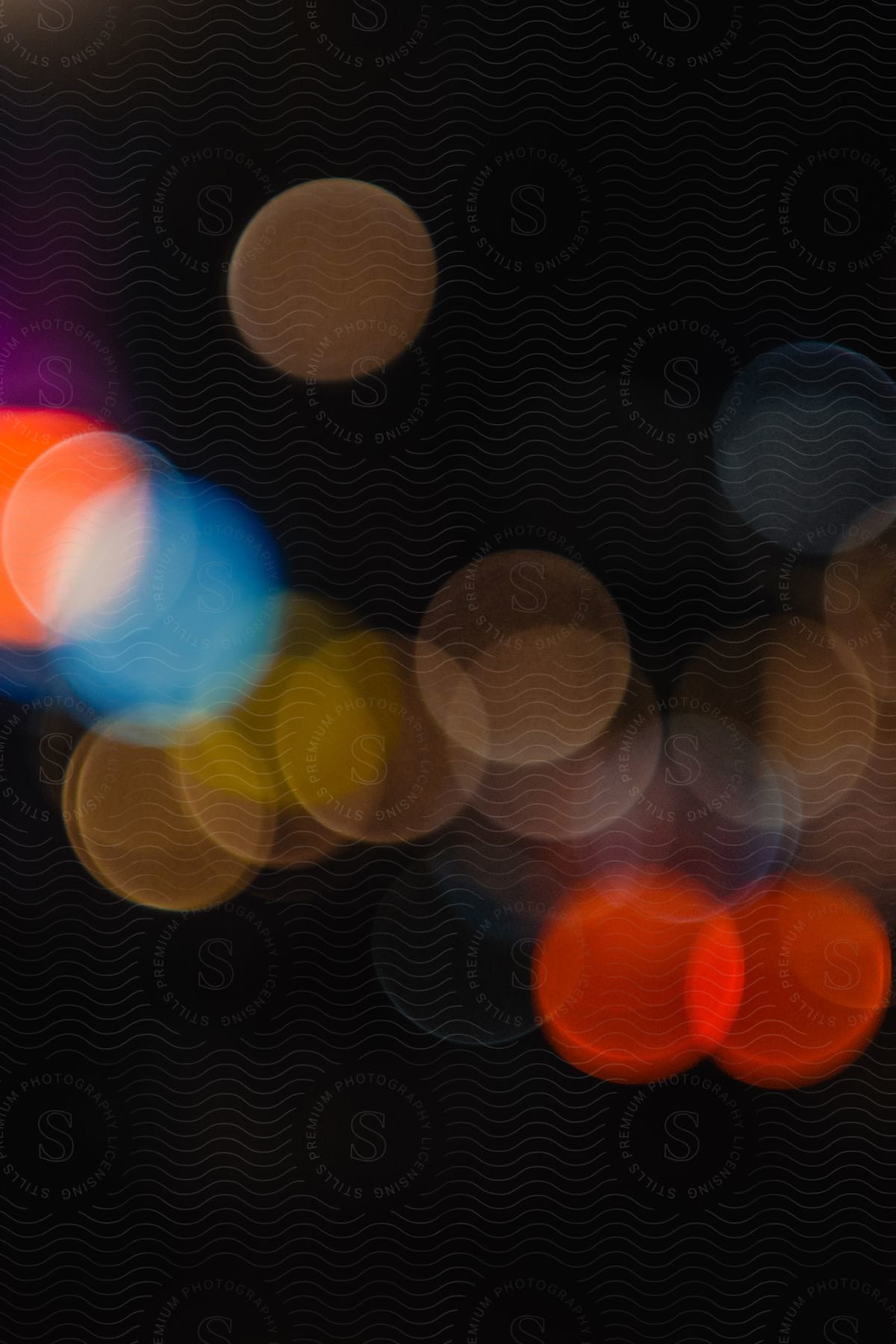 Circles of colorful lights overlaid on each other against a black background