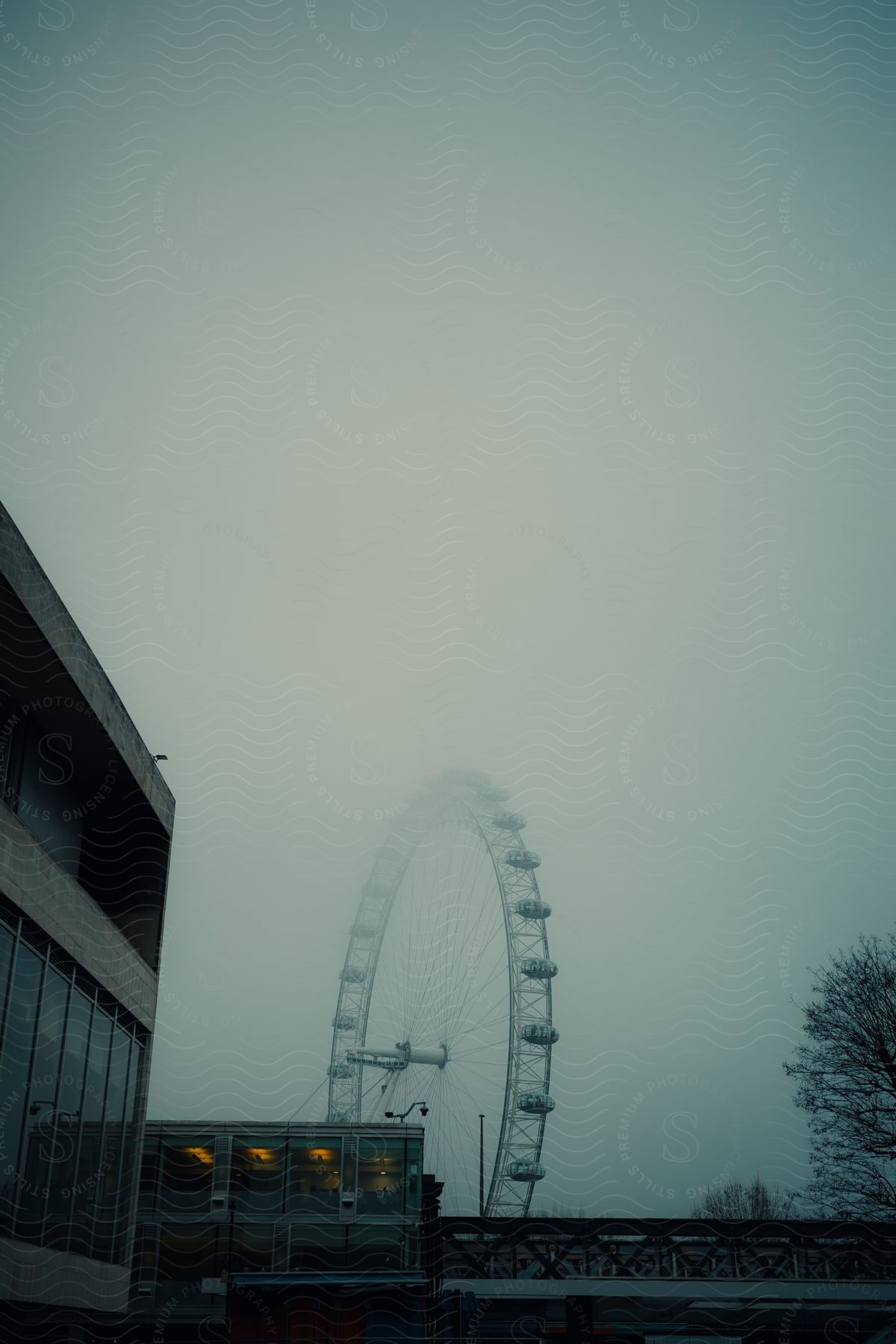 Panorama of urban buildings with a station and a ferris wheel in the background on a cloudy day