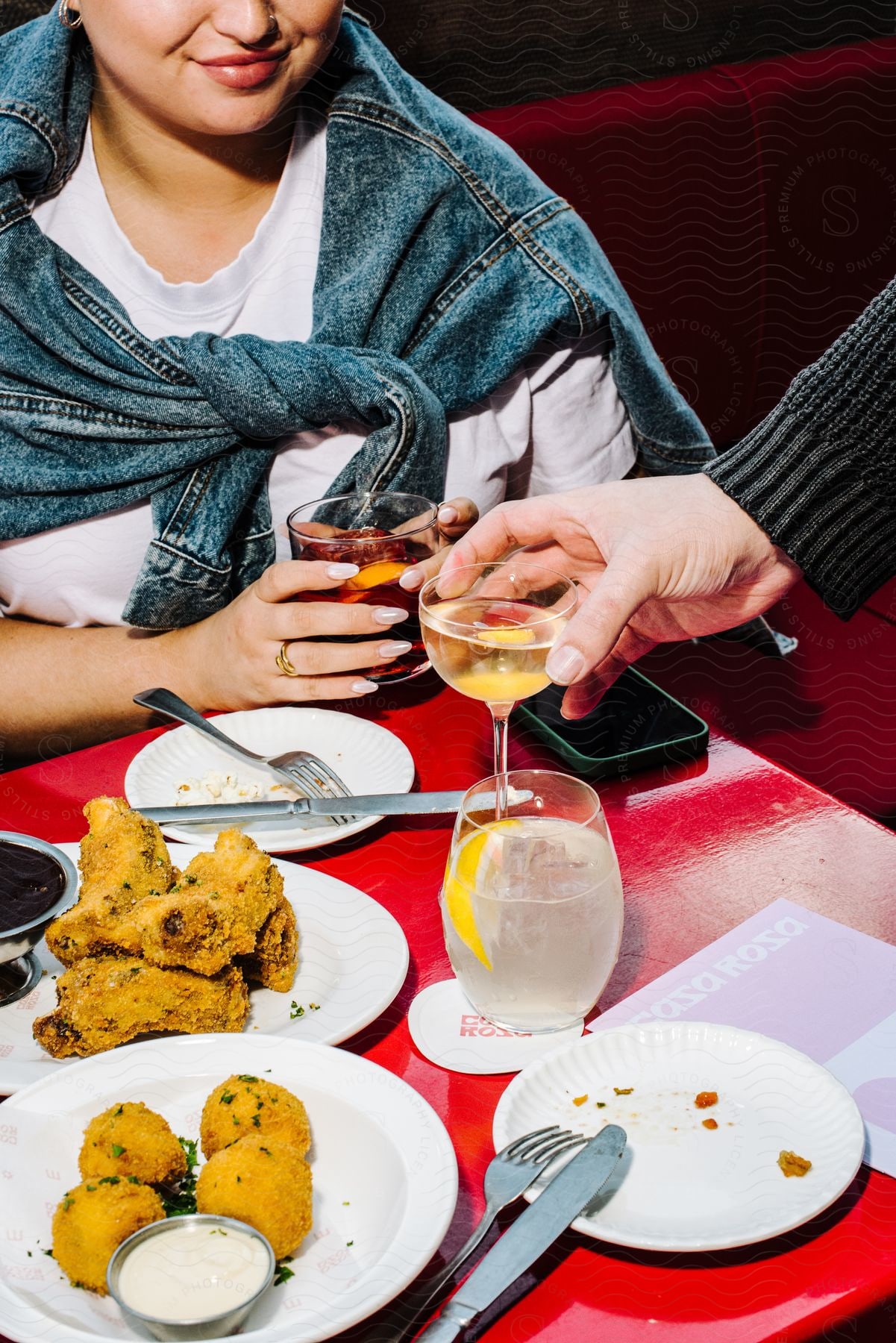 A woman getting served drinks in a restaurant