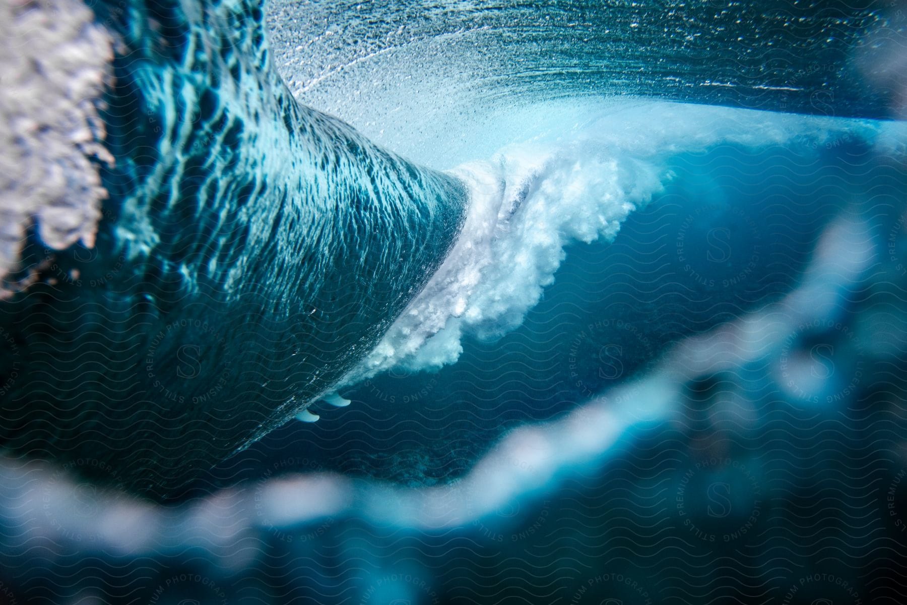 A wave surges across the water, gaining momentum as it travels.