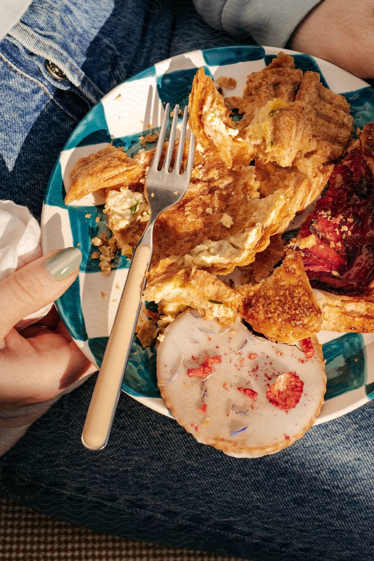 Close-up on a plate with sweet and savory puff pastries in a woman's hand.