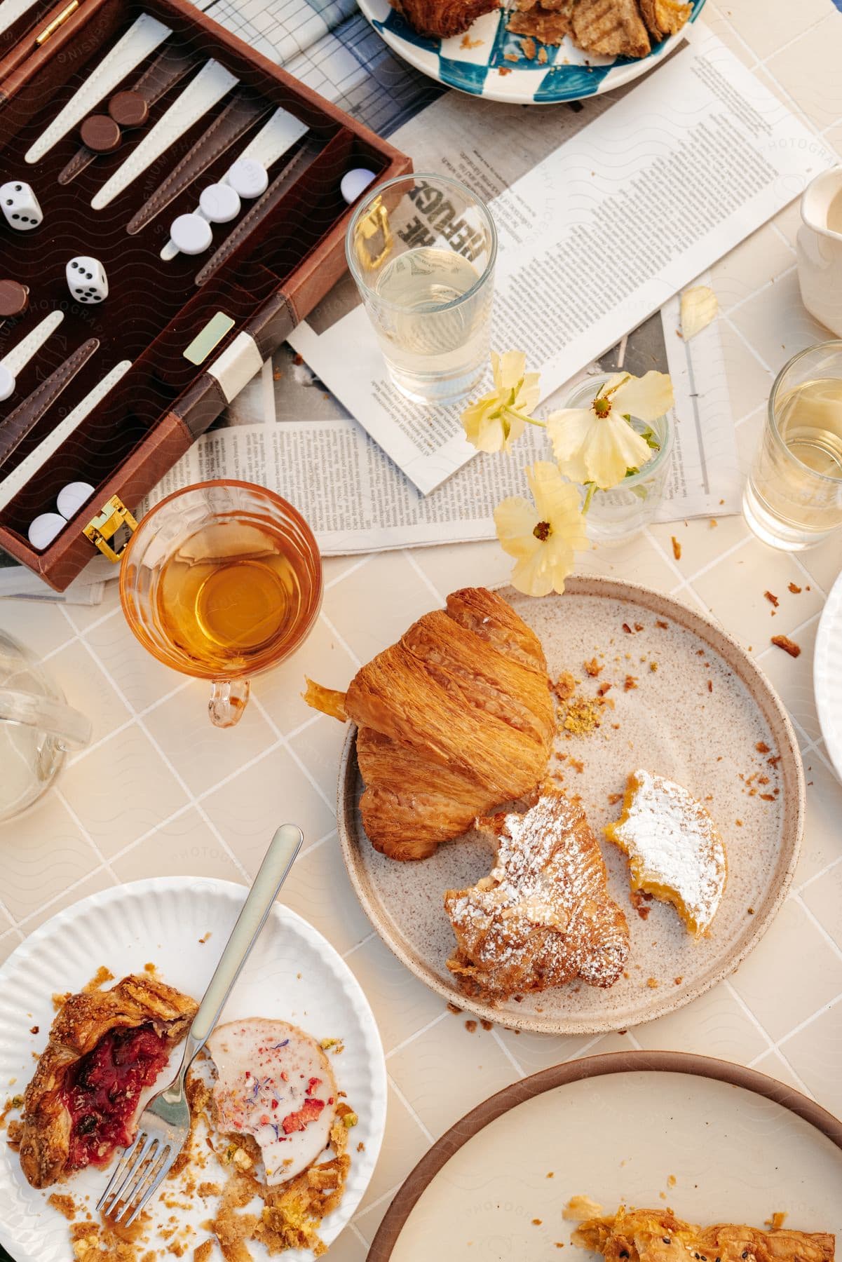 A view of a table outdoors with brunch food on it.