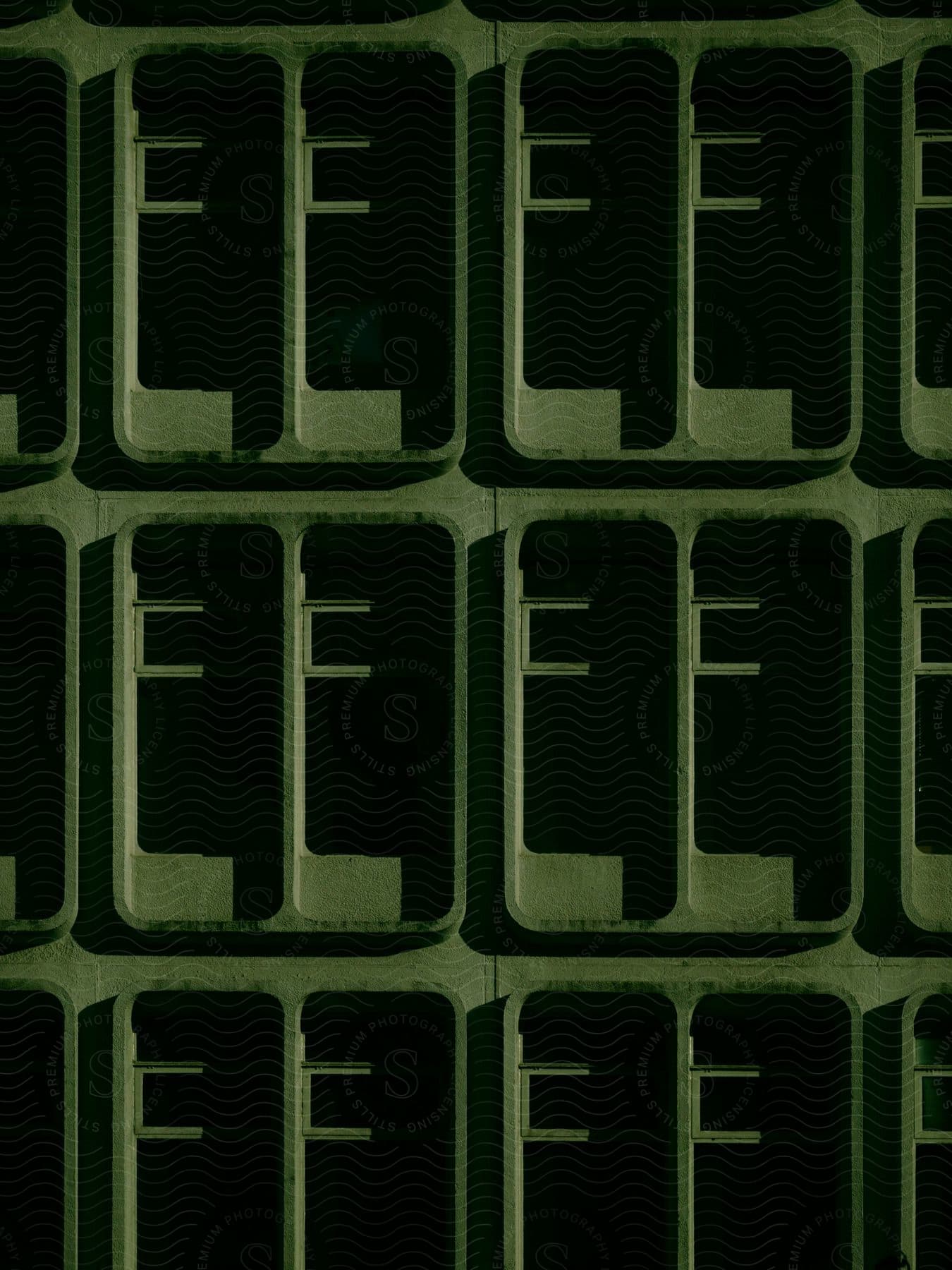 A repetitive pattern of dark green rectangles, each surrounded by a lighter border. The rectangles are arranged in horizontal and vertical lines, creating a grid-like structure.