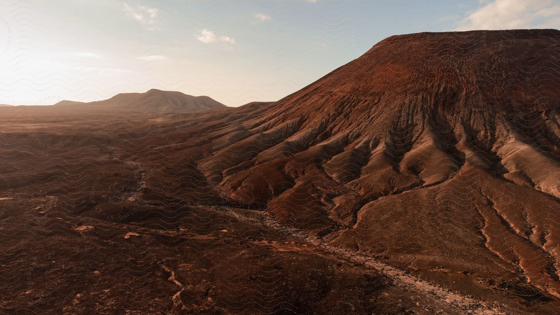 A desert region with dry soil and a small earthen hill