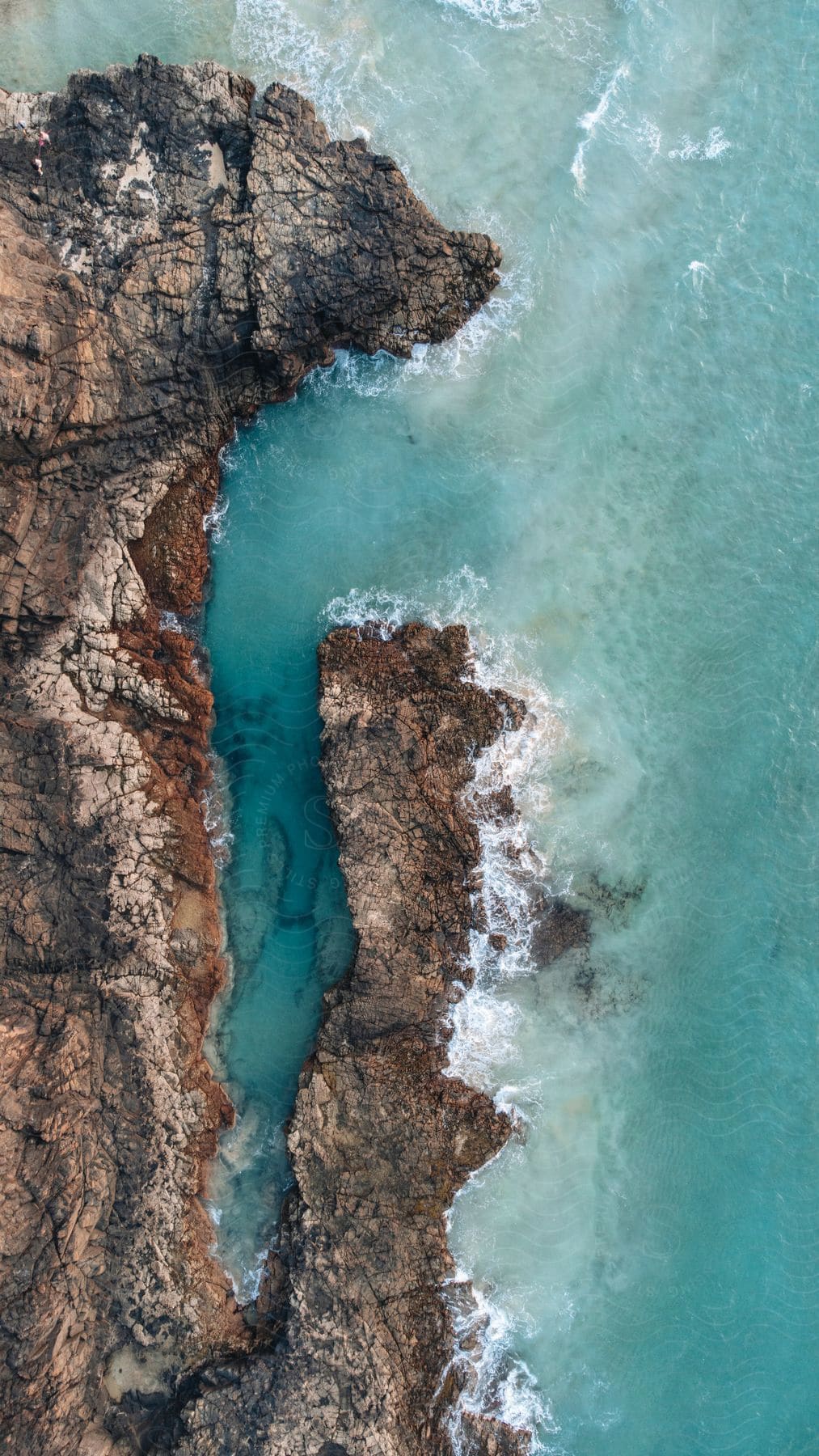 a rocky island surrounded by the sea