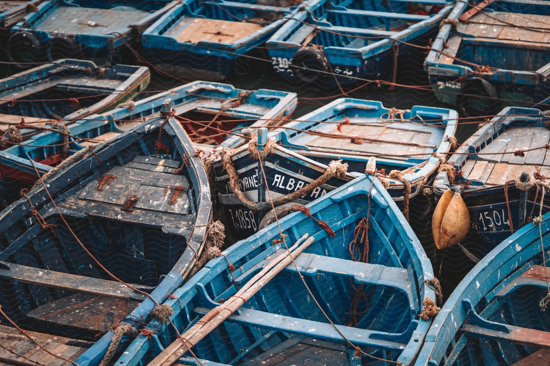 A series of canoes parked closely together.