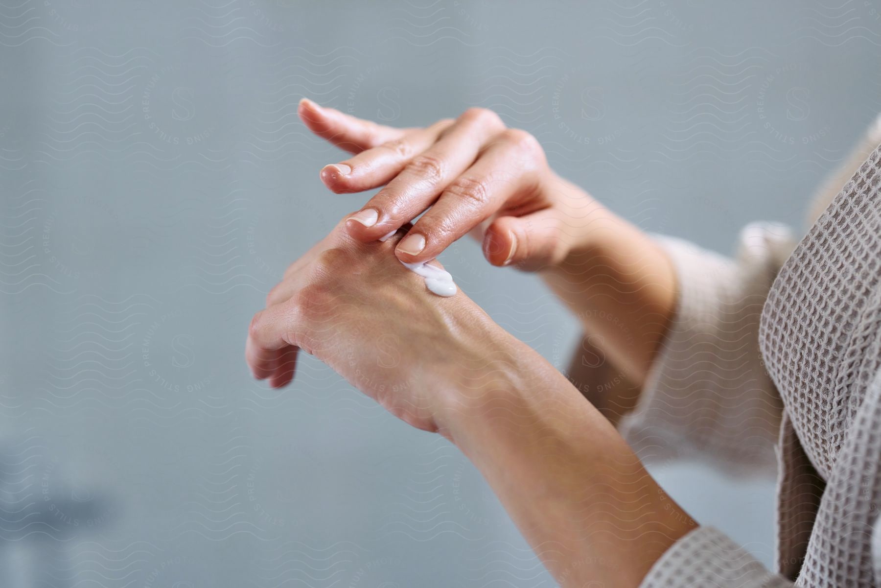 Close-up of a woman's hands applying cream