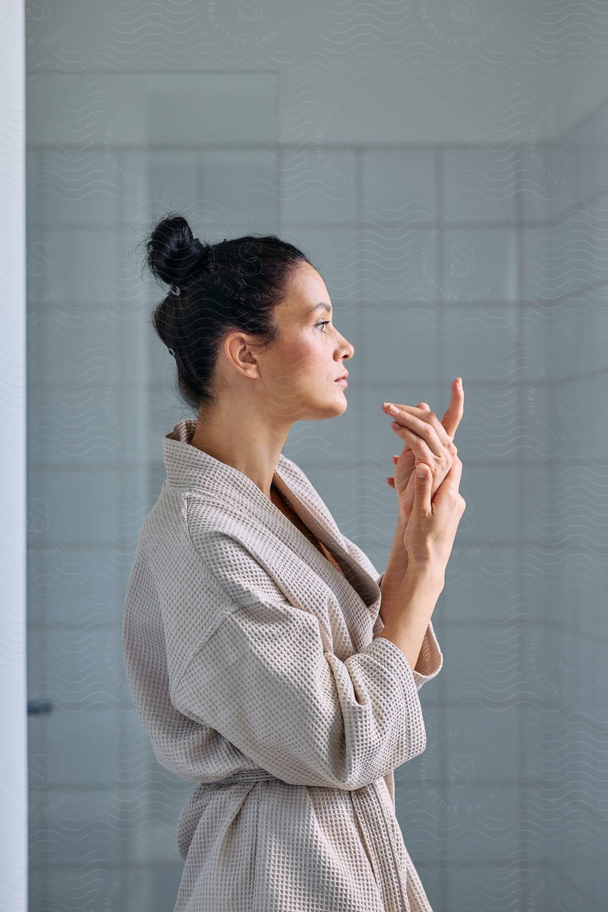 A woman wearing a robe in a bathroom