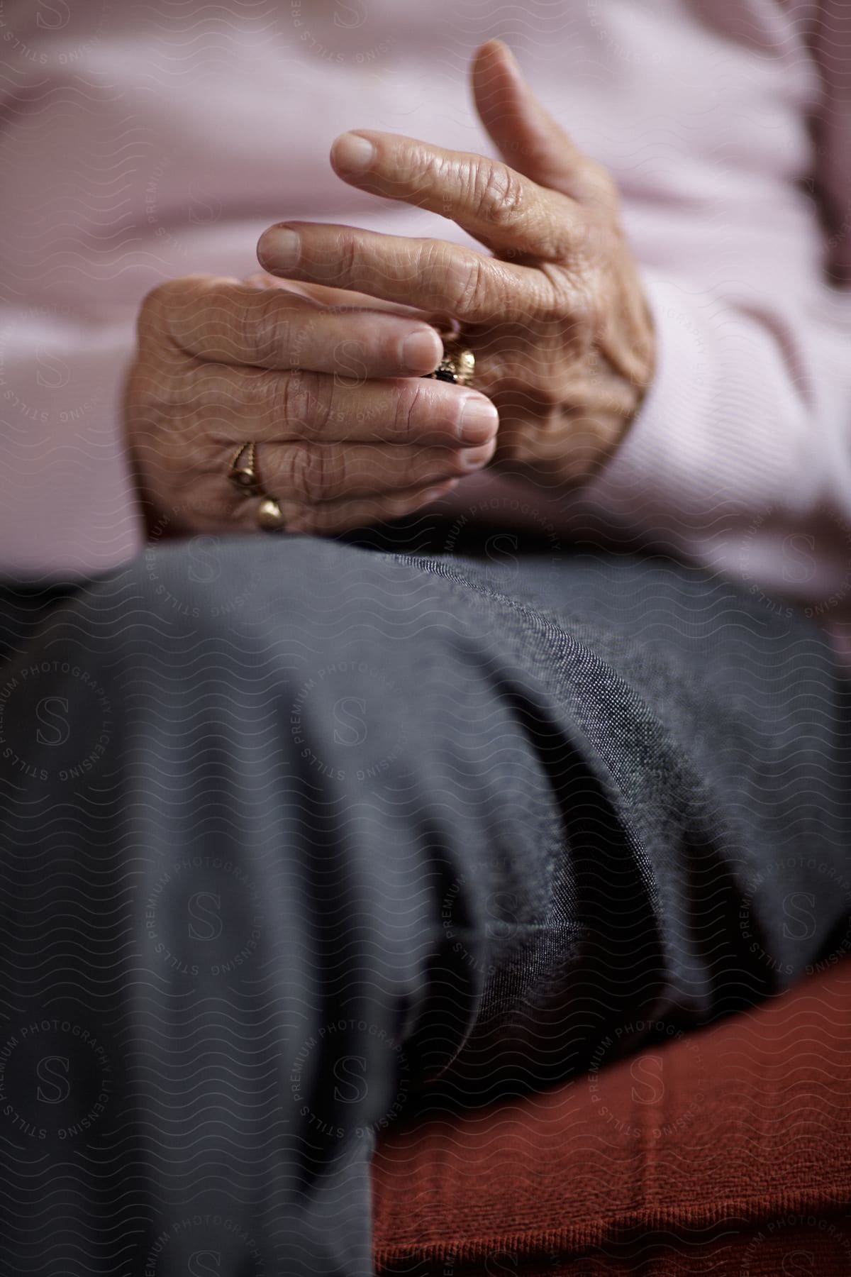 Person sitting down is moving with the rings on their finger