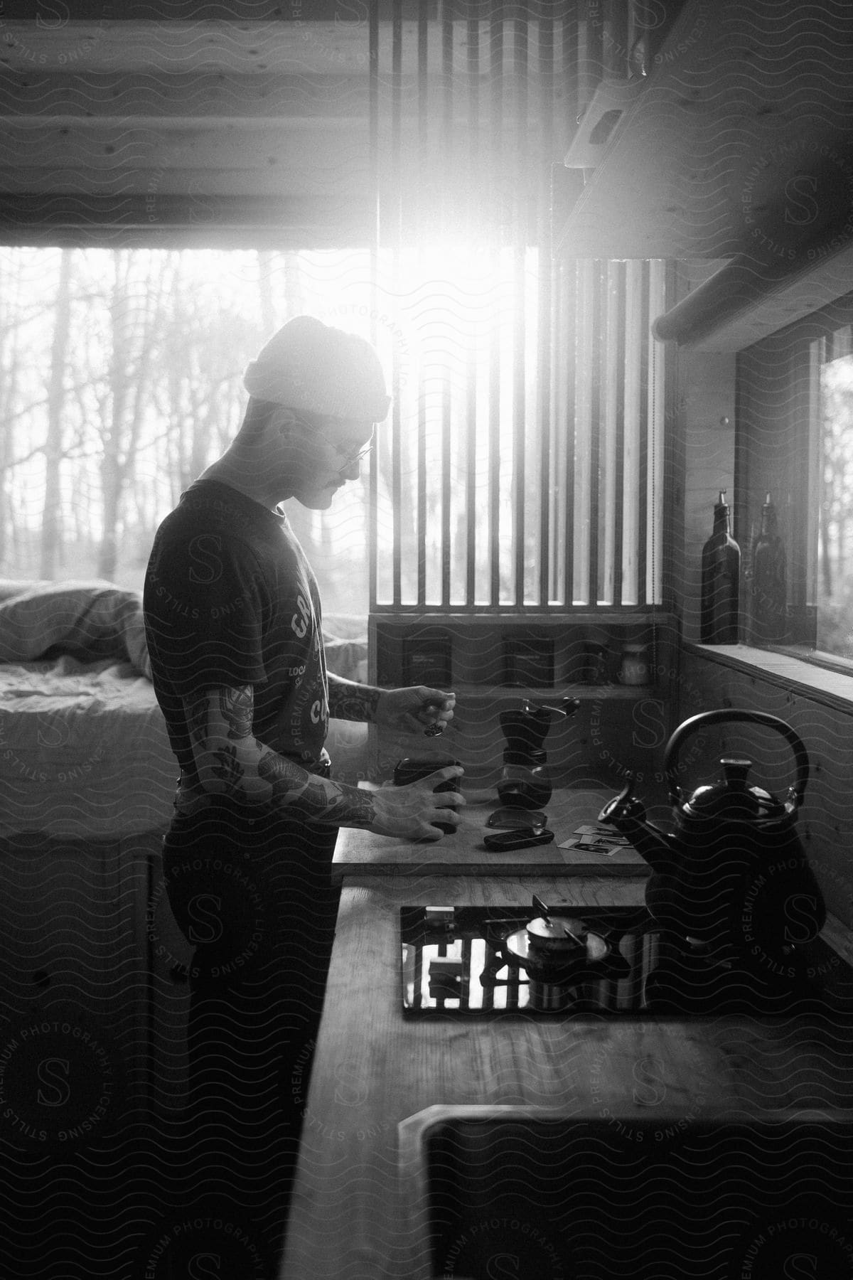 Stock photo of man standing in the kitchen preparing coffee