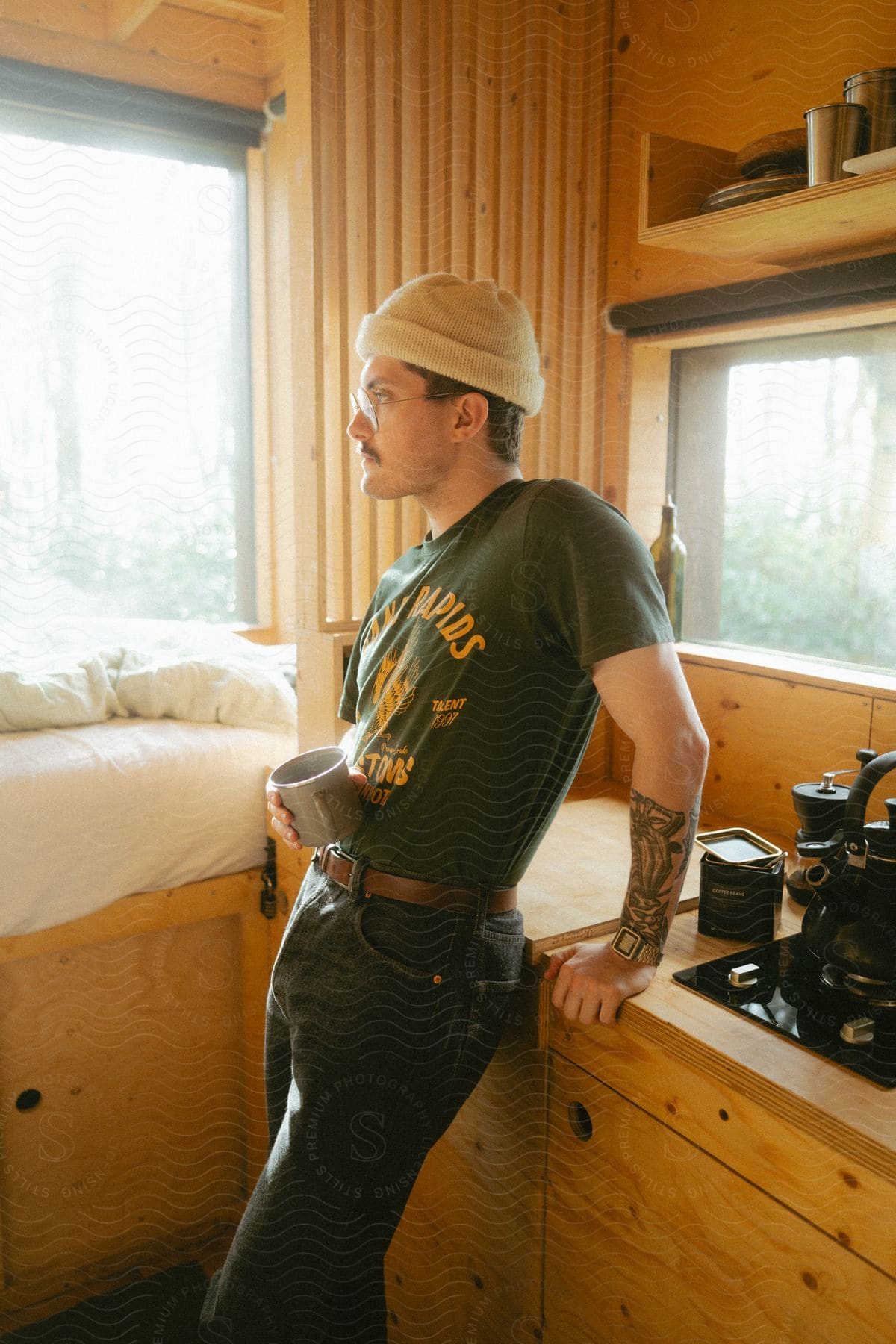 Man in the kitchen holding a mug.