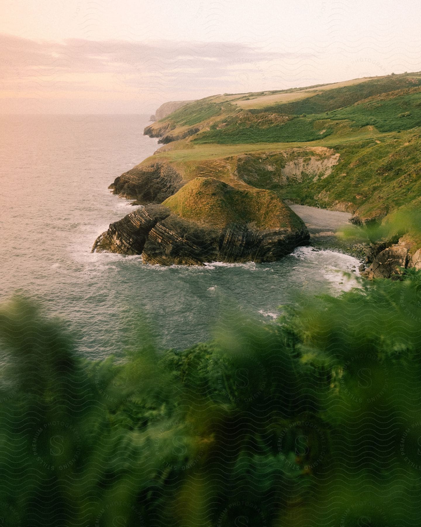 A coastal area with grassy plains and cliffs