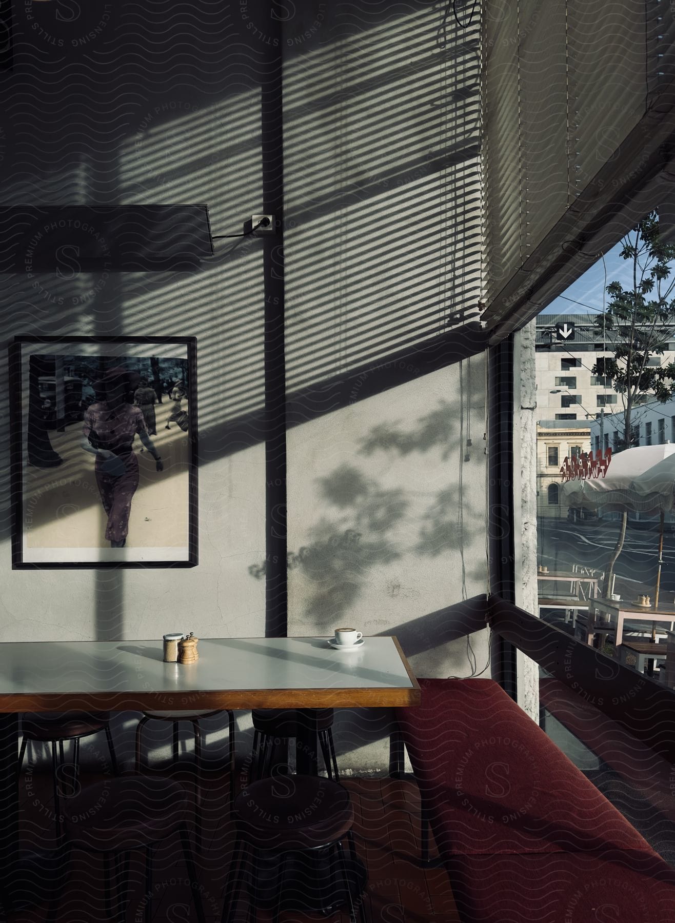 A view of the inside of a restaurant along a street.