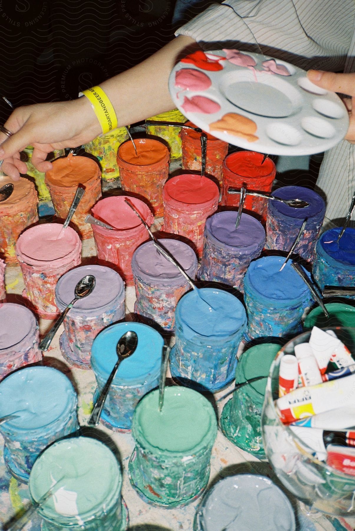 A number of paint tins from where a painter is picking colors to work with.