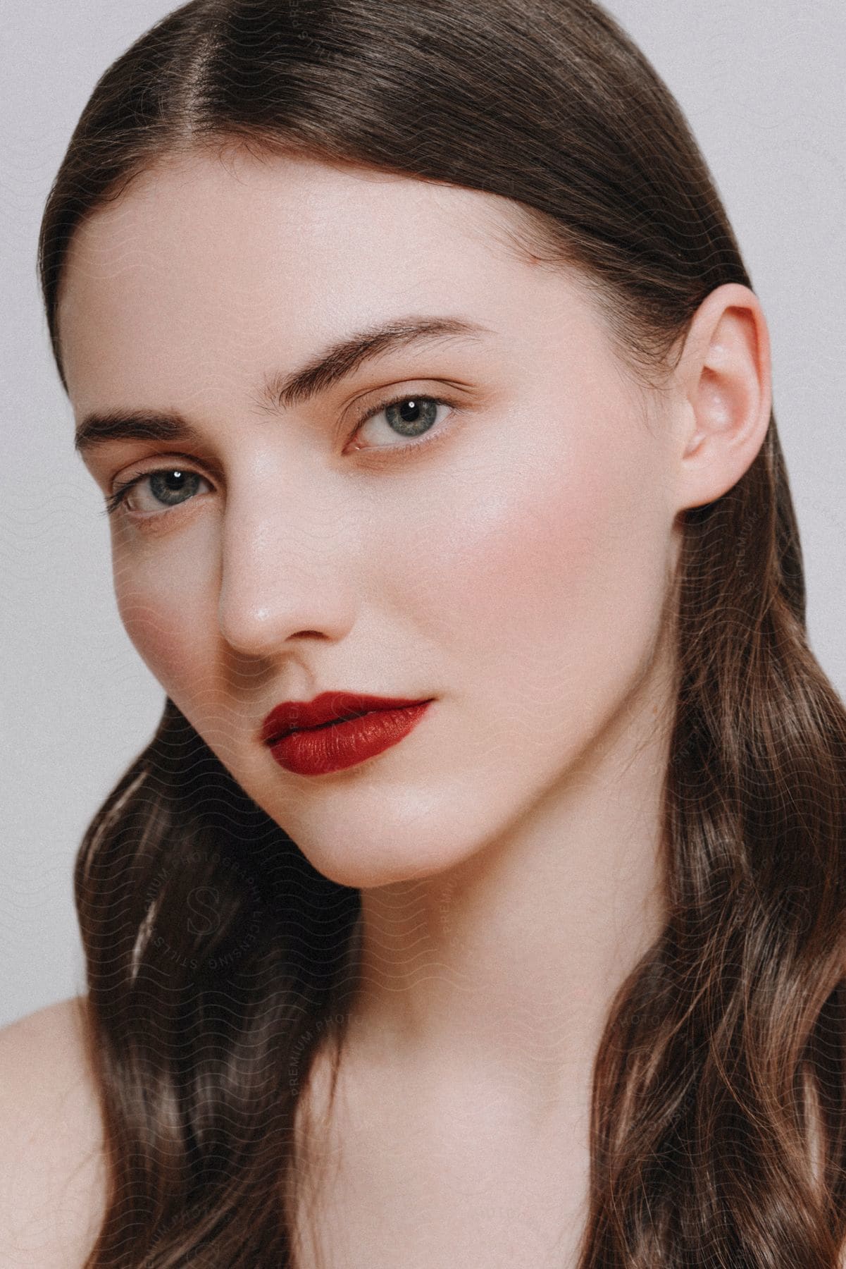 Portrait of a young woman with blue eyes and red lipstick