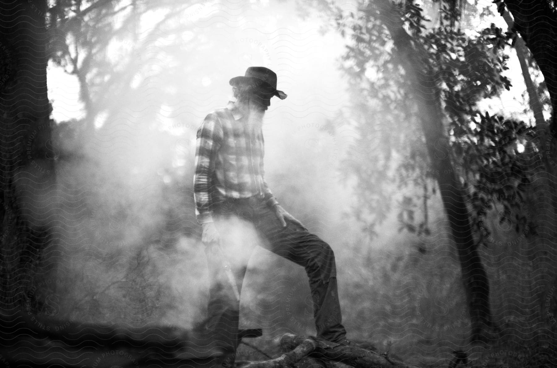 A man standing outdoors in the forest