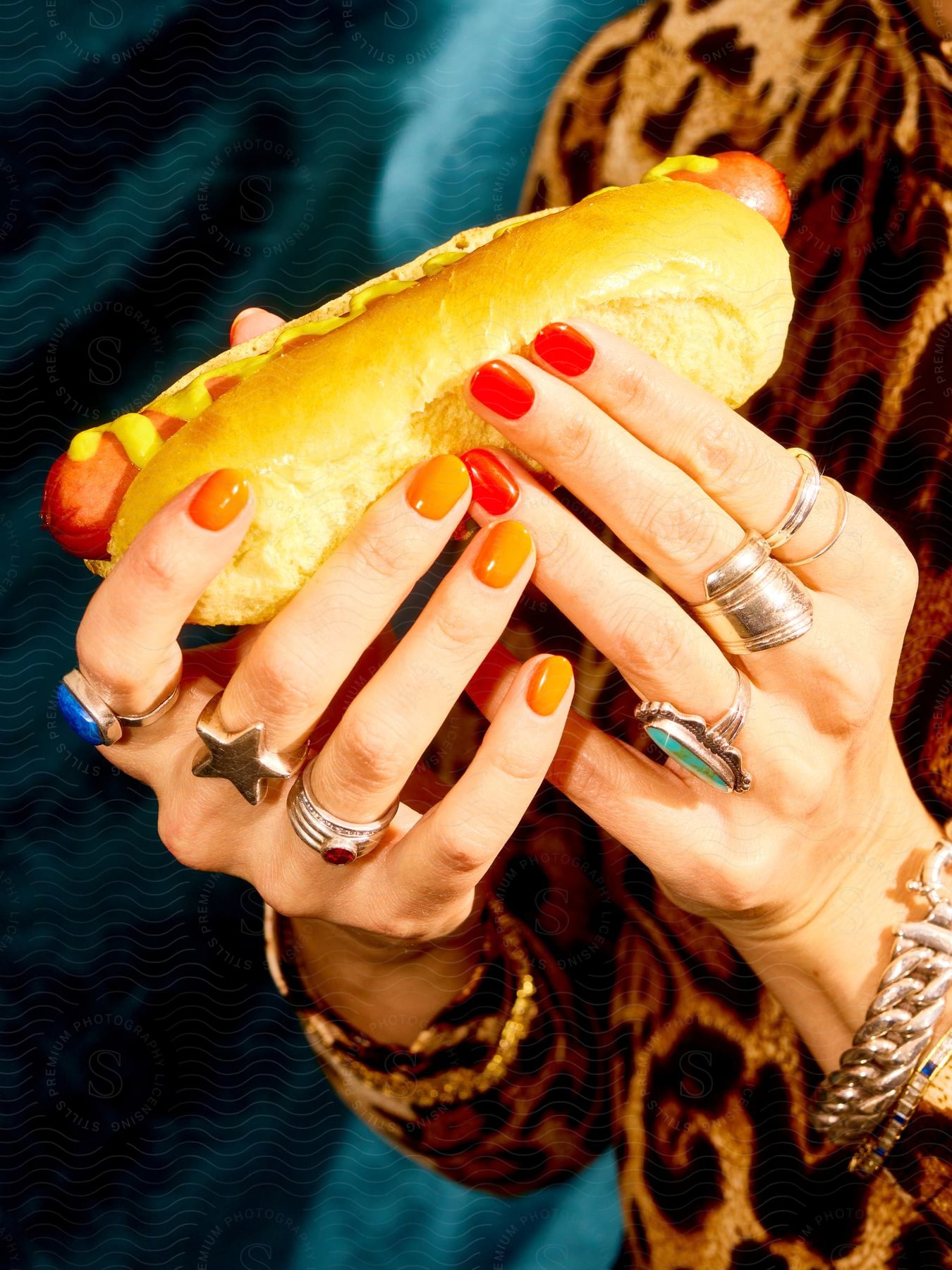 Woman holds a hotdog with both hands