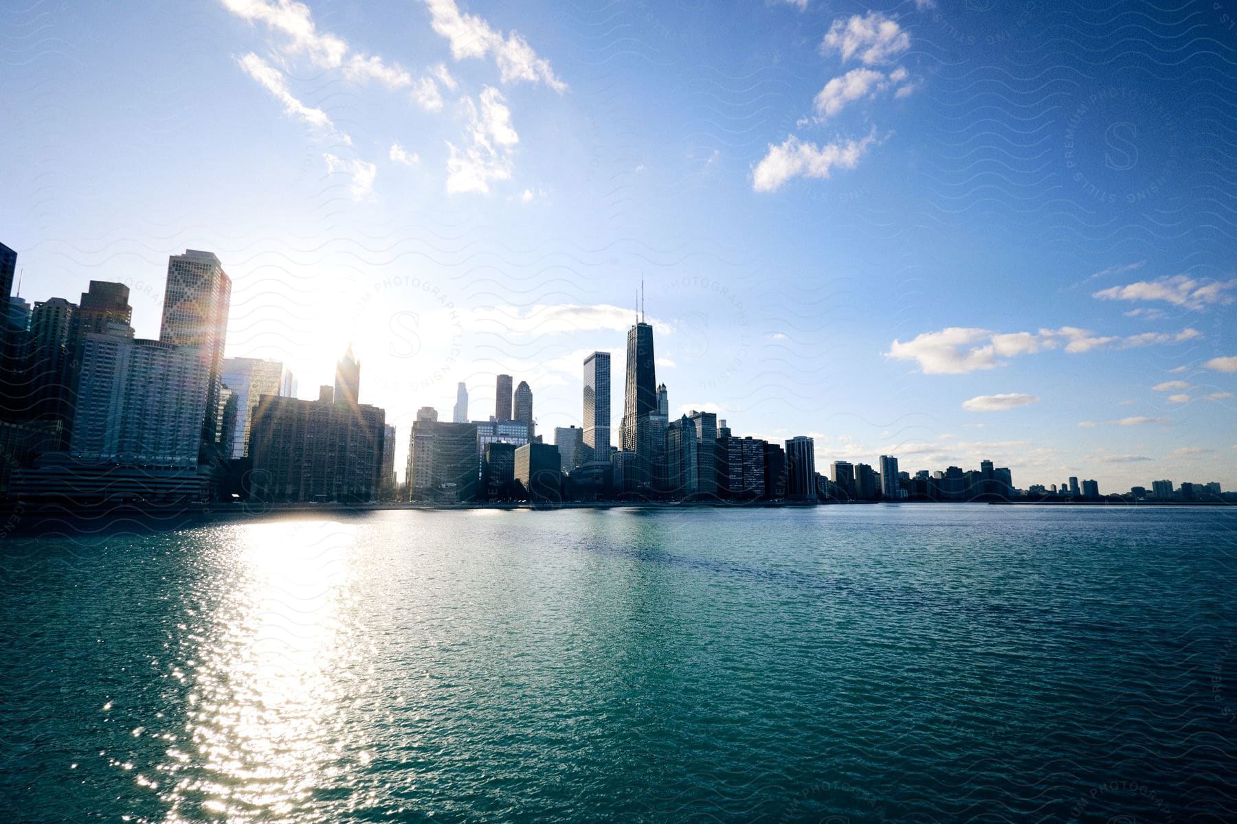 Panorama of a metropolis with seaside skyscrapers and solar reflection.