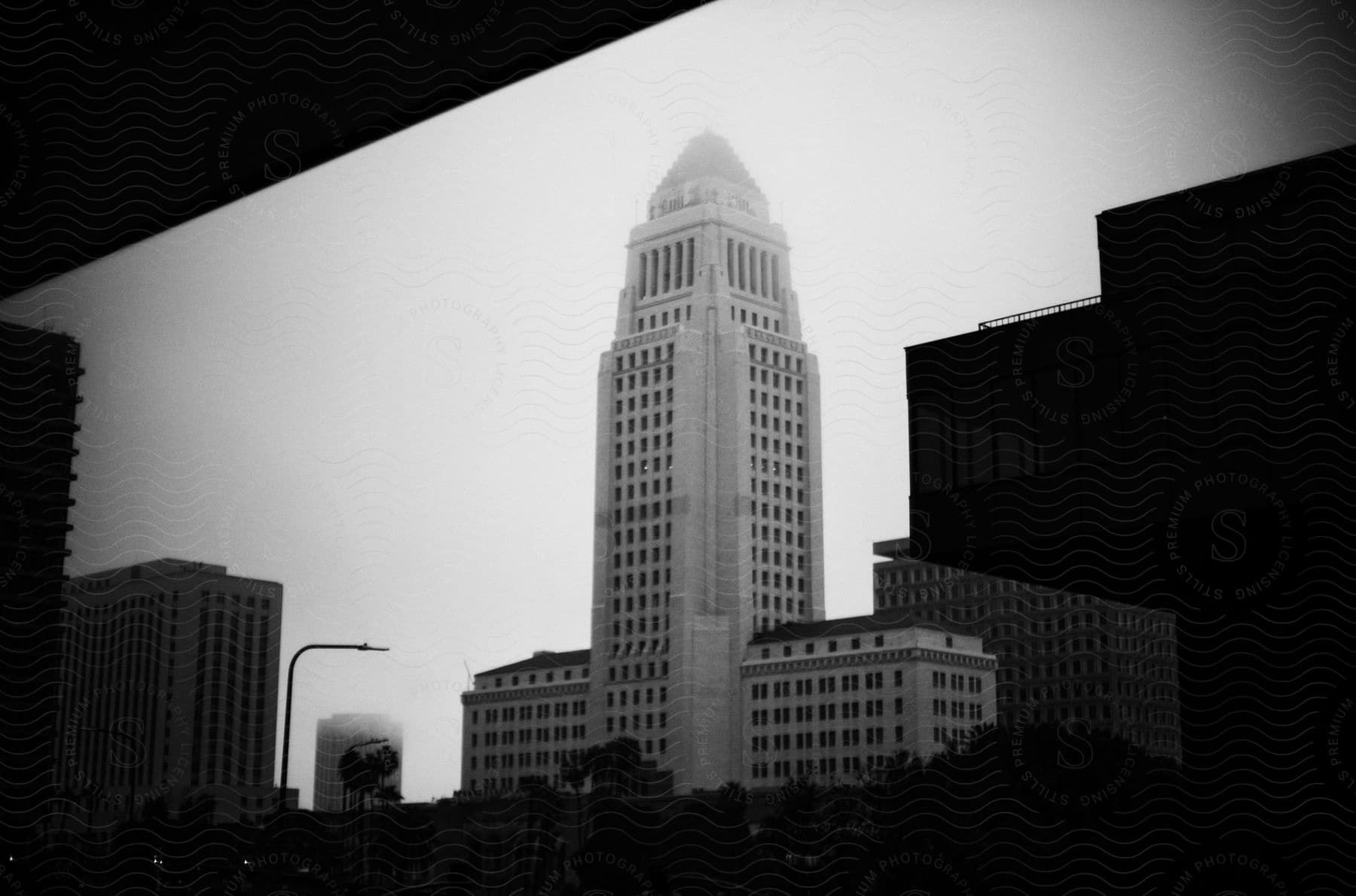 Cityscape with a prominent historical building at the center surrounded by other urban structures