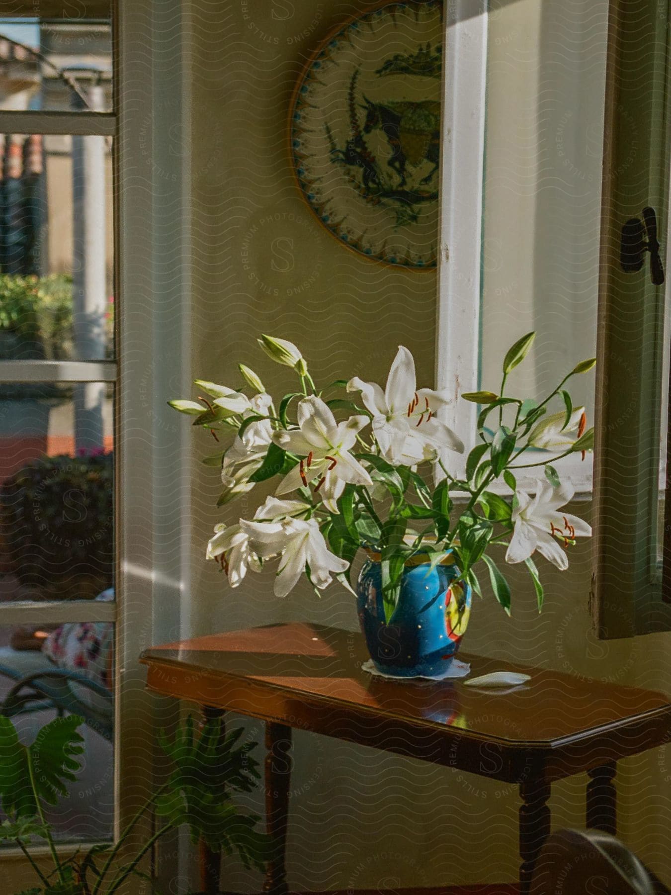 A white floral arrangement brightens a hallway table in a cozy home.