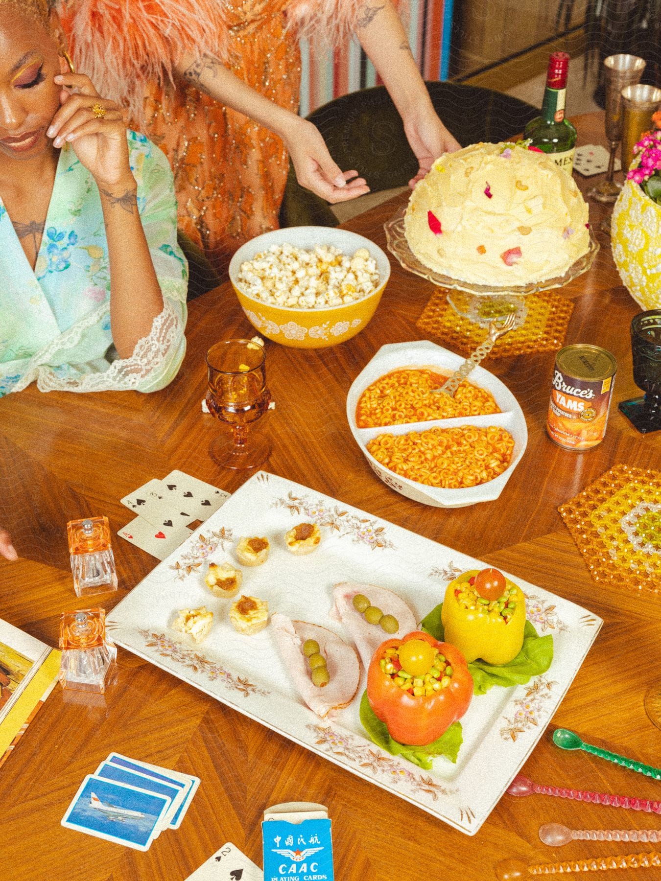 Colorful table spread with cake, popcorn, deviled eggs, and a person in the background.