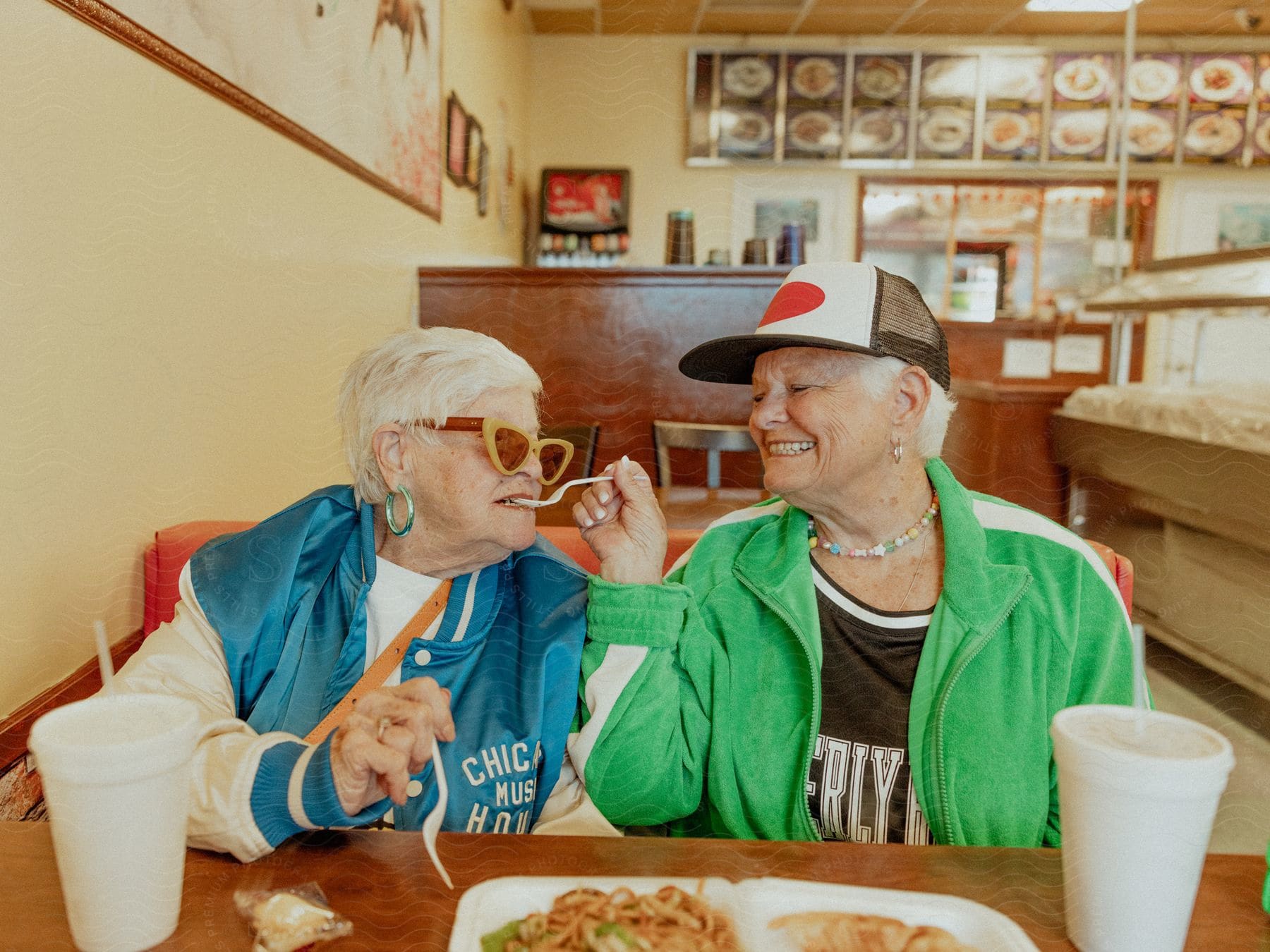 Two elderly women sharing a meal at a Chinese restaurant.