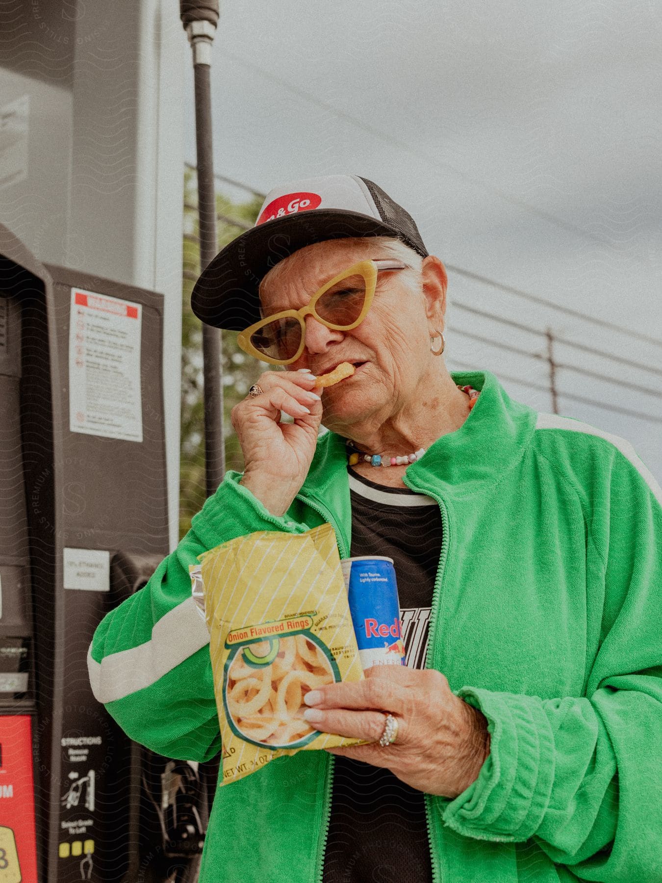 An old woman eating some snacks at a gas station