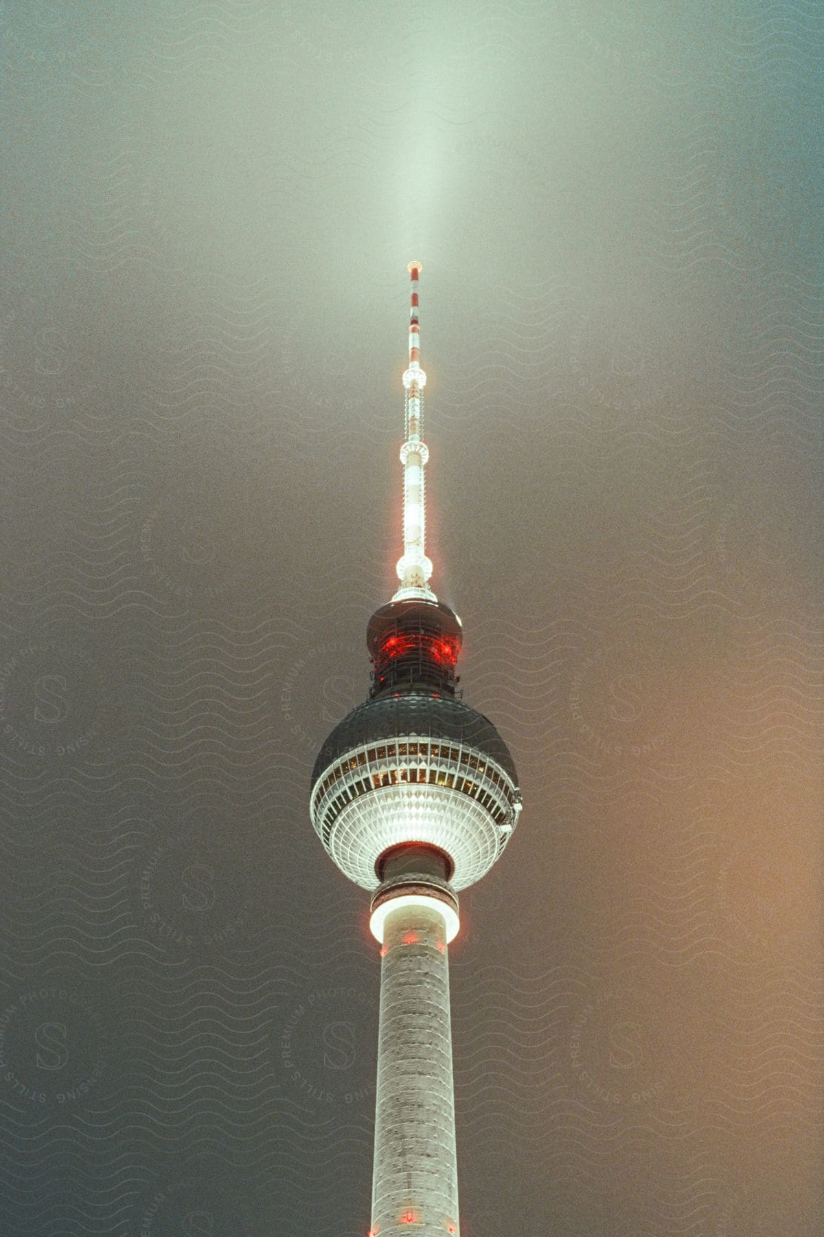 A tower spire outdoors at night with lights on it