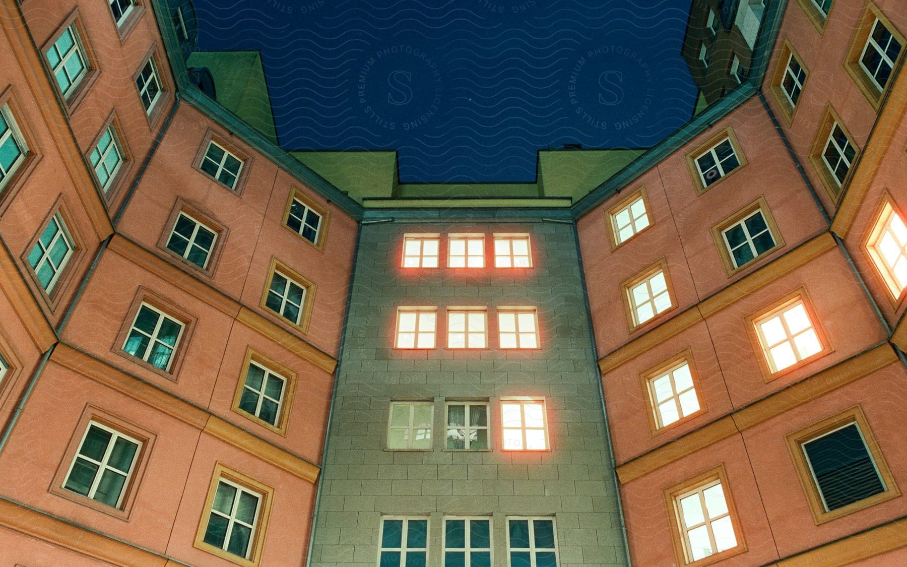 Lights in windows of an apartment building glow