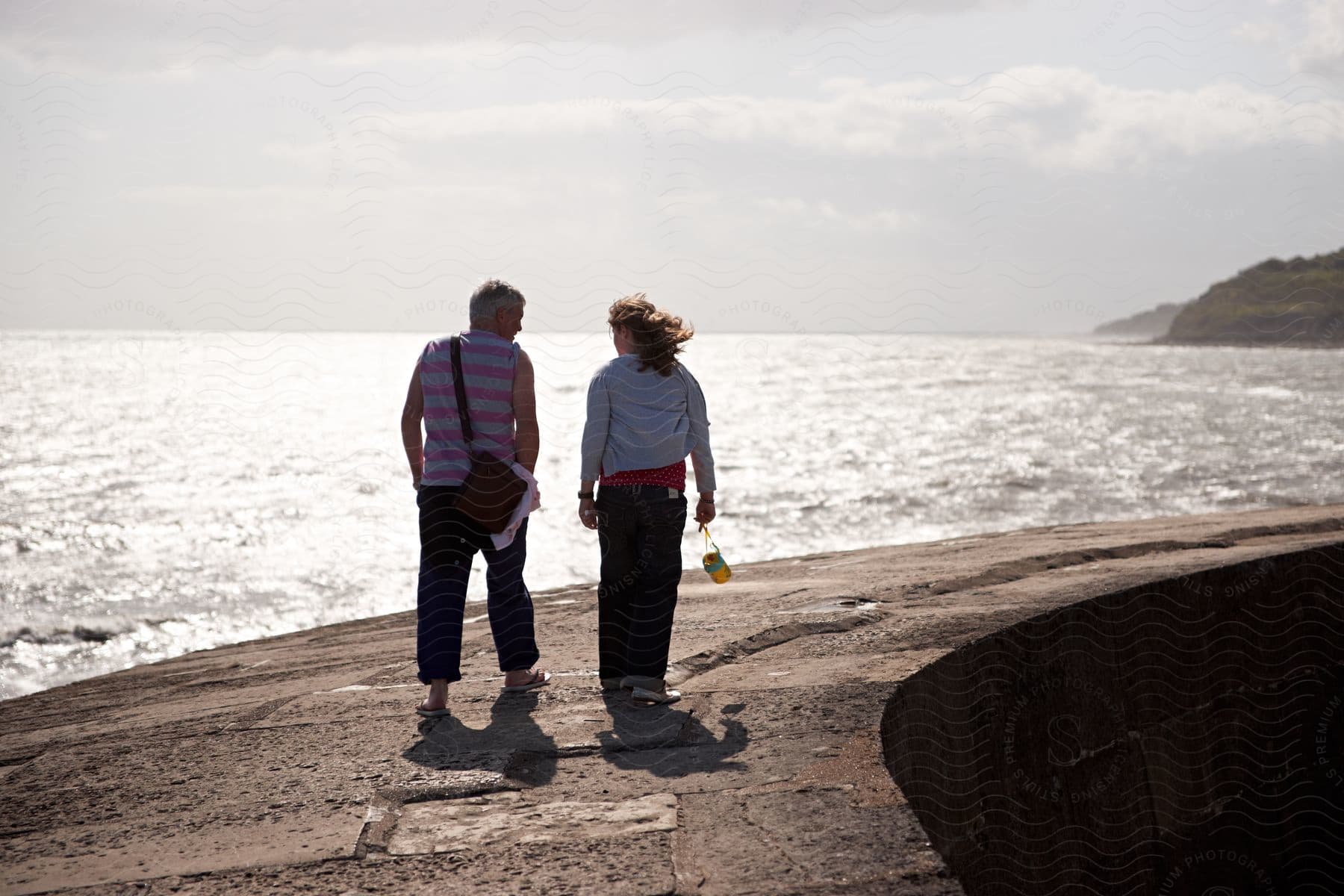 A man and woman walking together along a beach