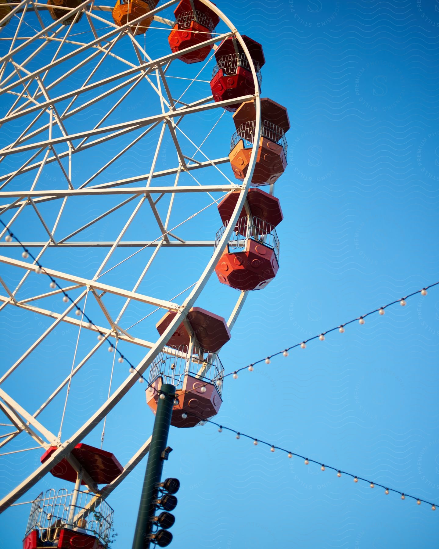 A colorful Ferris wheel stands out against a clear blue sky.