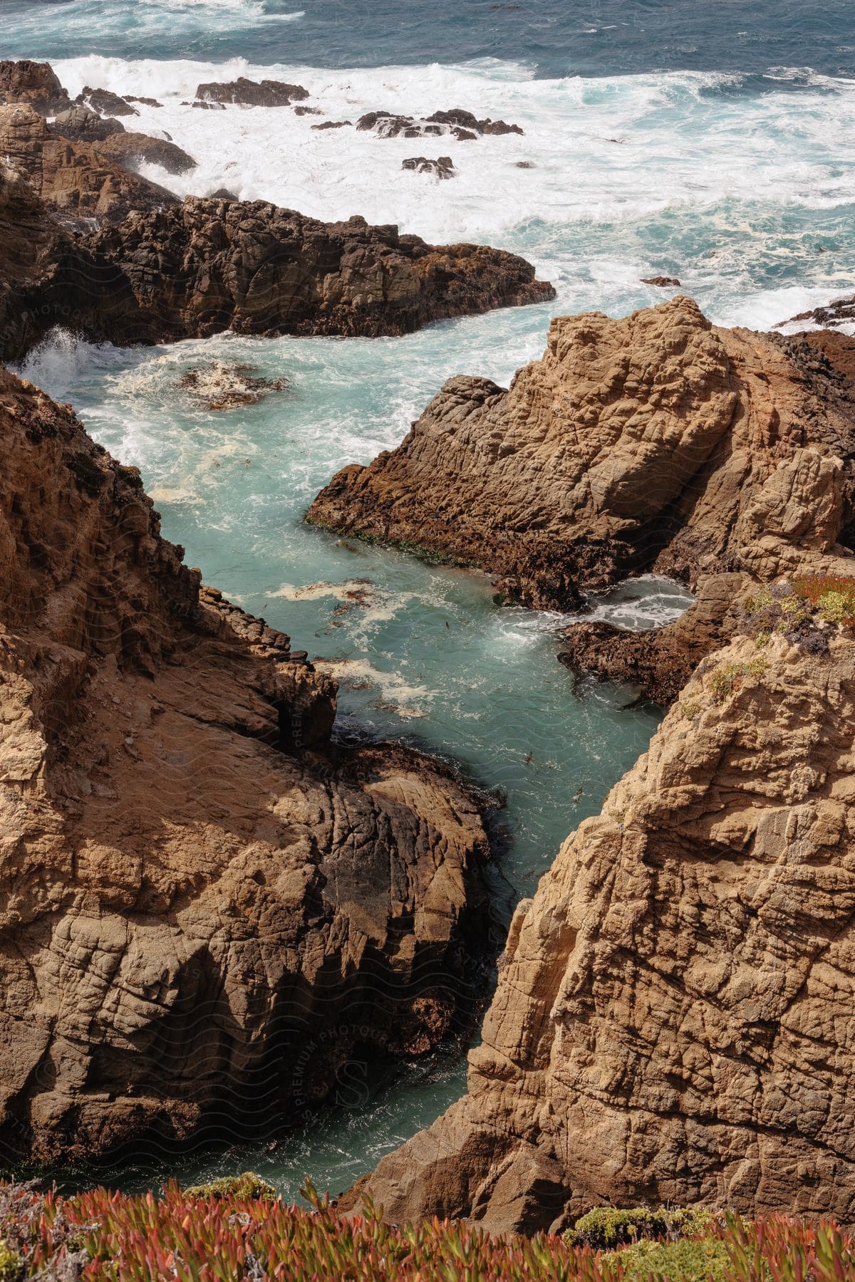 The coast with some rocks and water around it