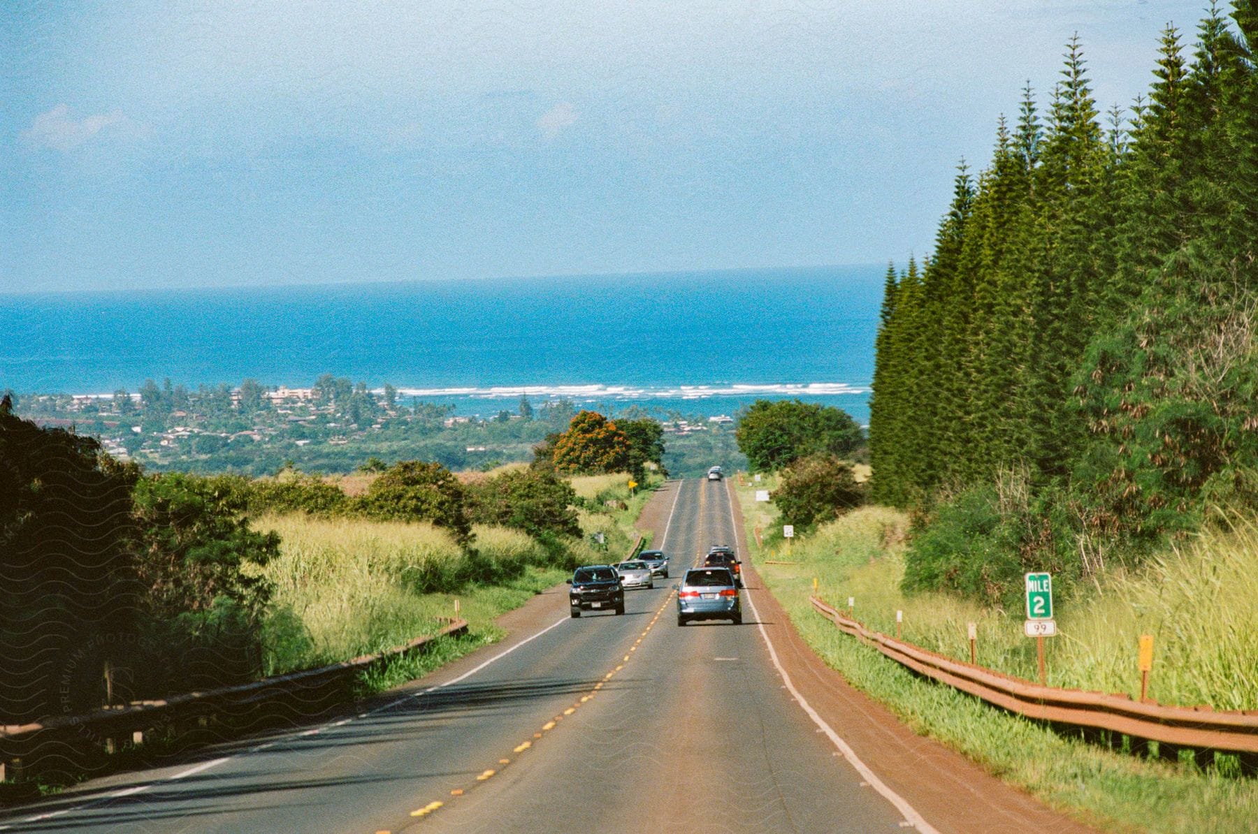 Light traffic on a road with the coast and ocean in the distance